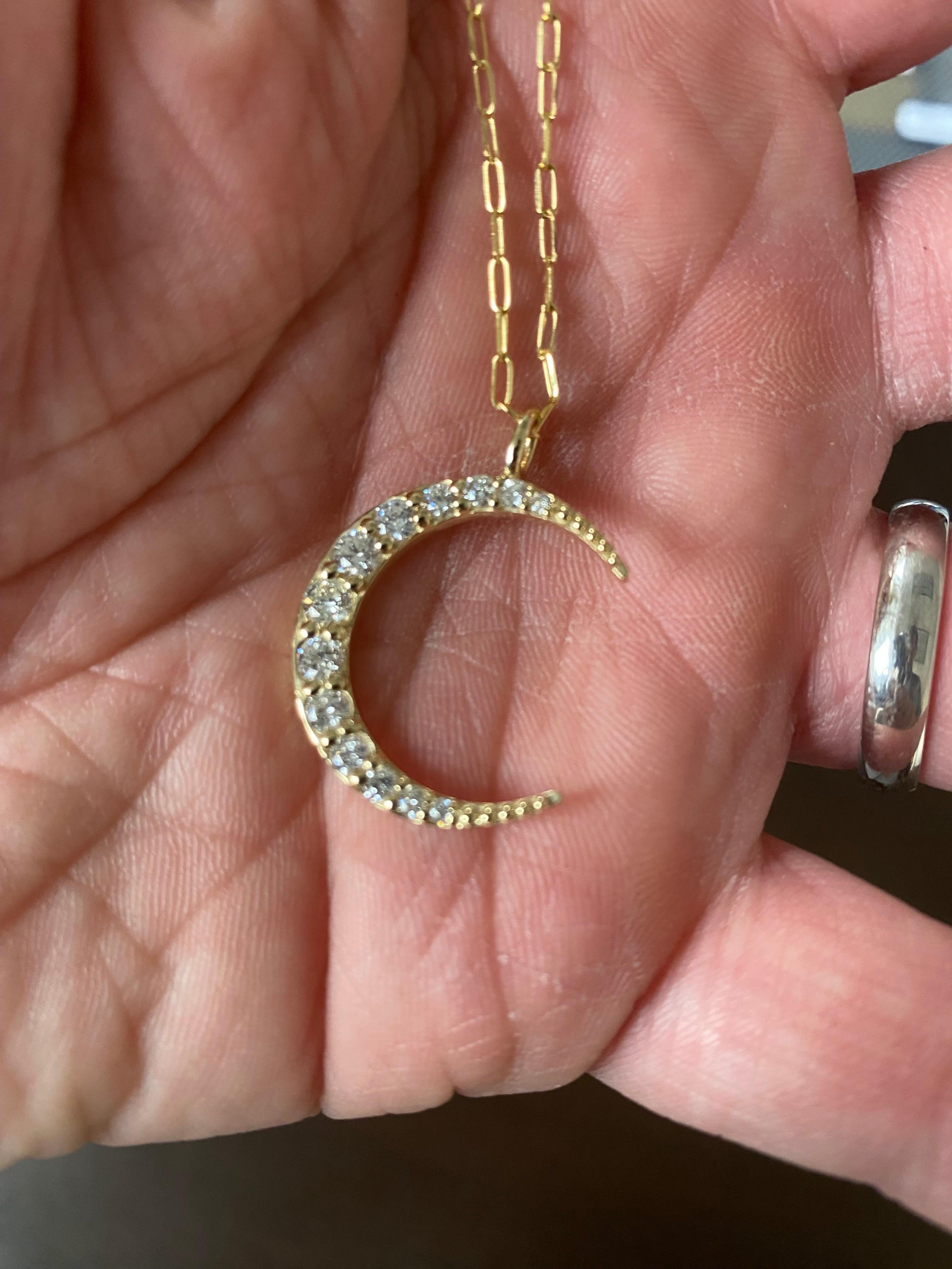 Graduated diamond moon shaped pendant set in 14K yellow gold. The total diamond weight is 1.37 carats. The color of the stones are G-H, the clarity is SI2. 