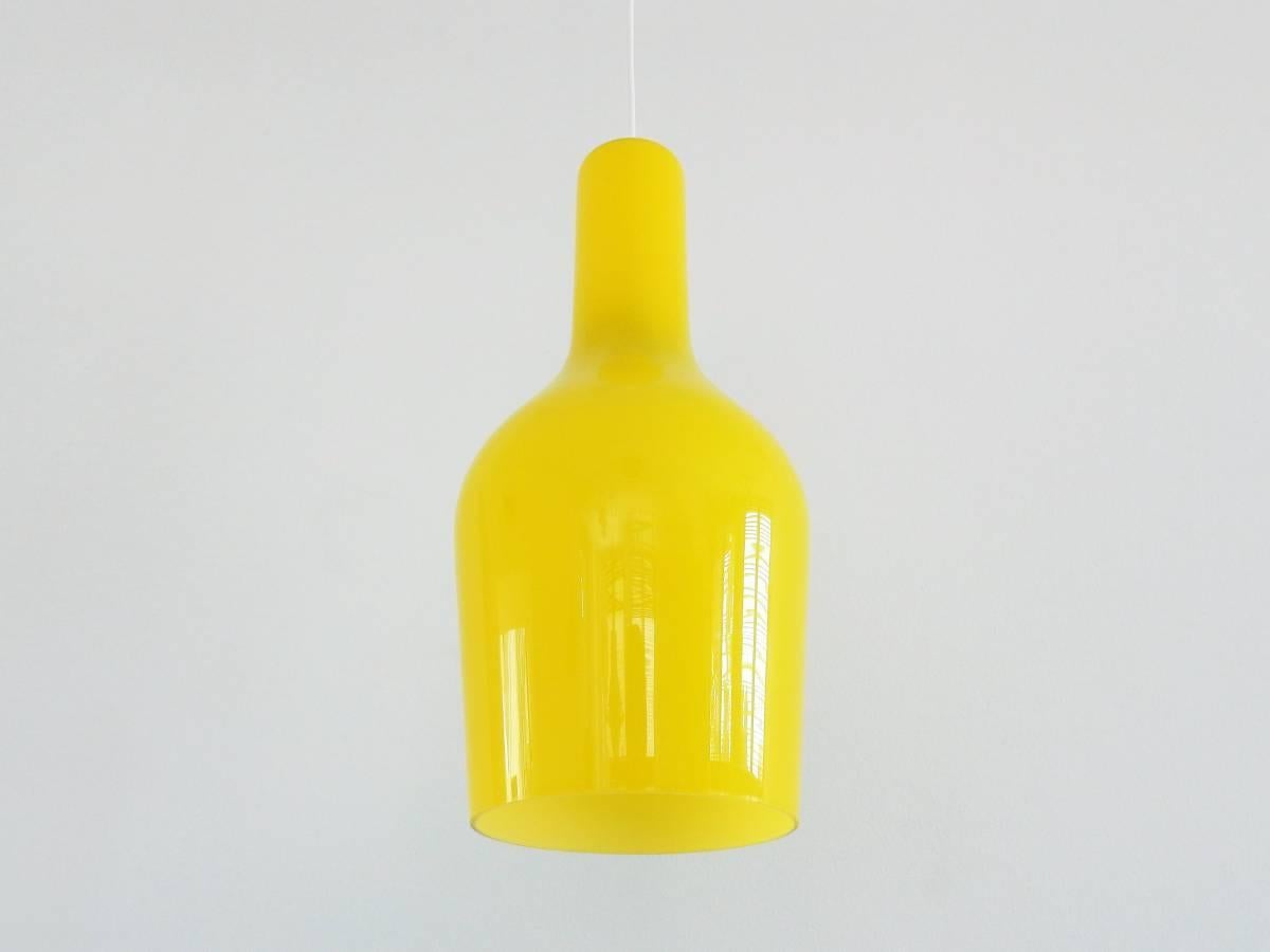 This yellow glass pendant lamp is in a very good to excellent condition. Bright yellow glass outside with a white opaline inside. This gives a very nice light. Documented in the 'Indoor' catalogue of 1967.