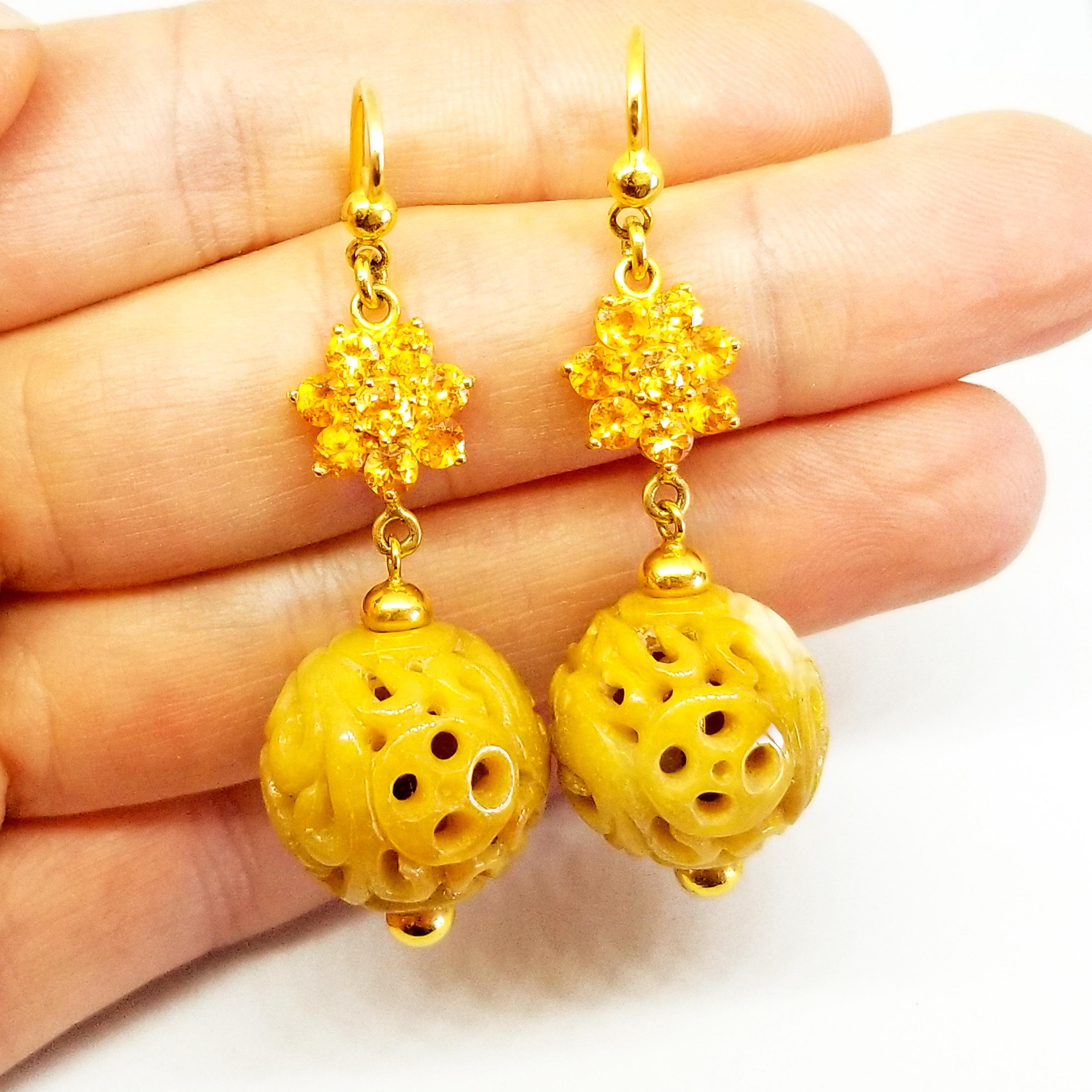 These Long and Elegant Earrings are One of a Kind in 14K Yellow Gold feature Floret Clusters of Round Brilliant Cut Sapphires of Deep Orange Yellow Hue and Gem Quality. The prong set Sapphires measure 3mm each and the fourteen stones combine for a