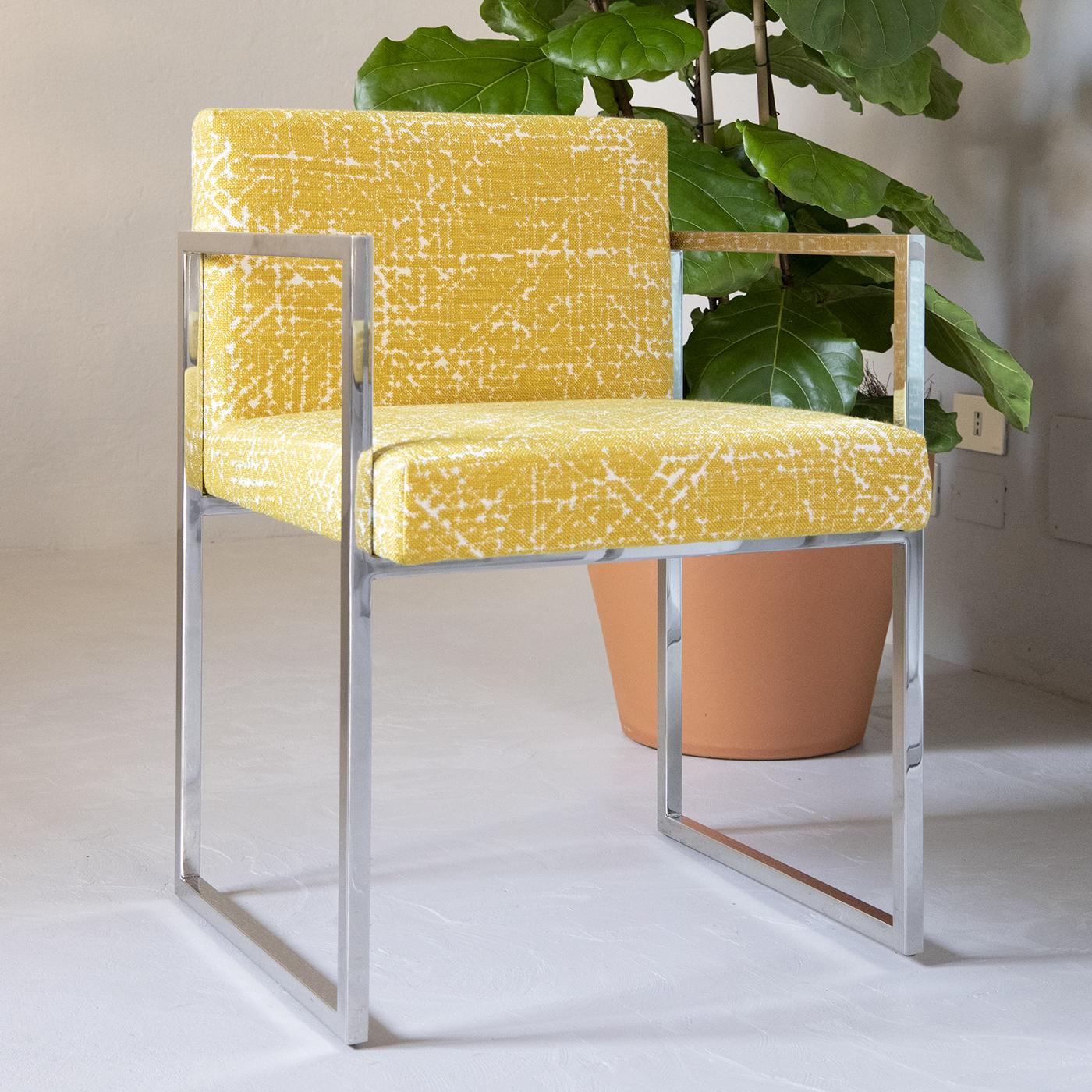 Designed by Gianna Farina and Marco Gorini, the stylish Paris Outdoor Chair is made with a polished stainless steel structure with seat and back featuring outdoor padding and upholstered in high-performance Rubelli fabric in yellow. Ideal for the