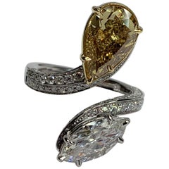 3.00 Carat Yellow Pear Shape and 1.52 Carat Marquis set in Two-Tone Bypass Ring