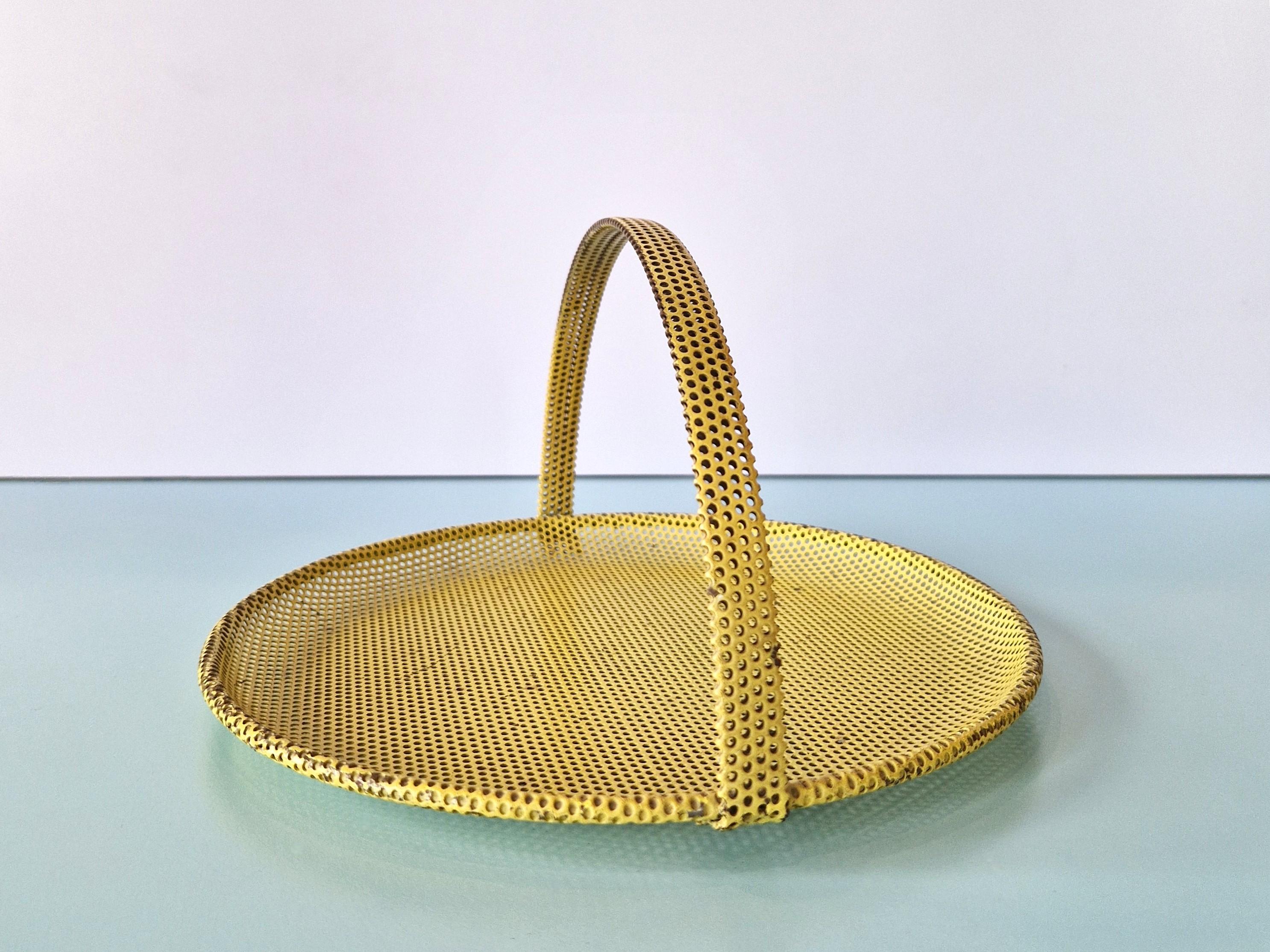 This perforated meteal tray/serving dish in yellow from the 1950's was designed by Mathieu Matégot. It is in a good original condition and it has a beautiful patina of age and use.

Parcel shipping with UPS