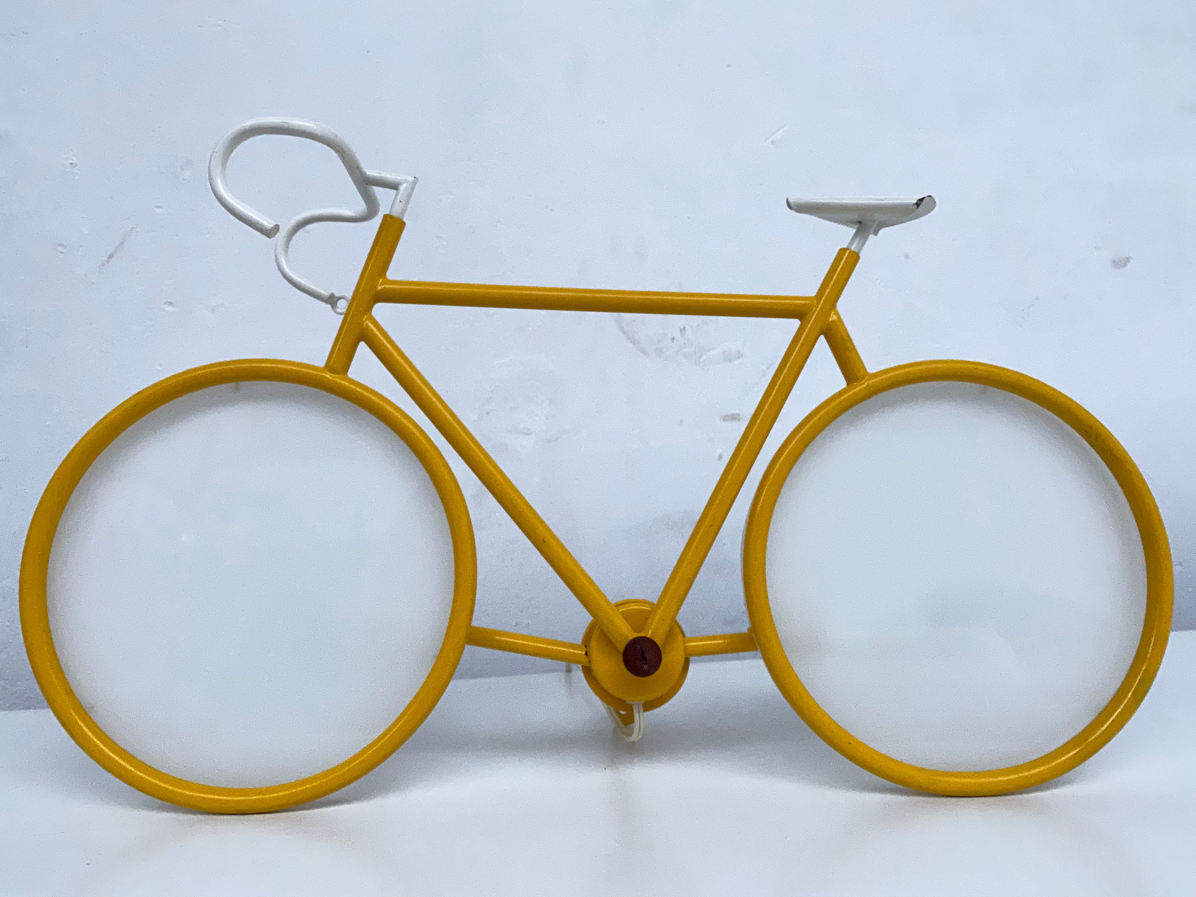 A fun statement on your wall or desk in the form of this 1970's Pop art racing bicycle by Italian lighting company Zicoli

Yellow steel frame and opal glass 'wheel' diffusers

This lamp can be wall mounted or be used as a table lamp and is