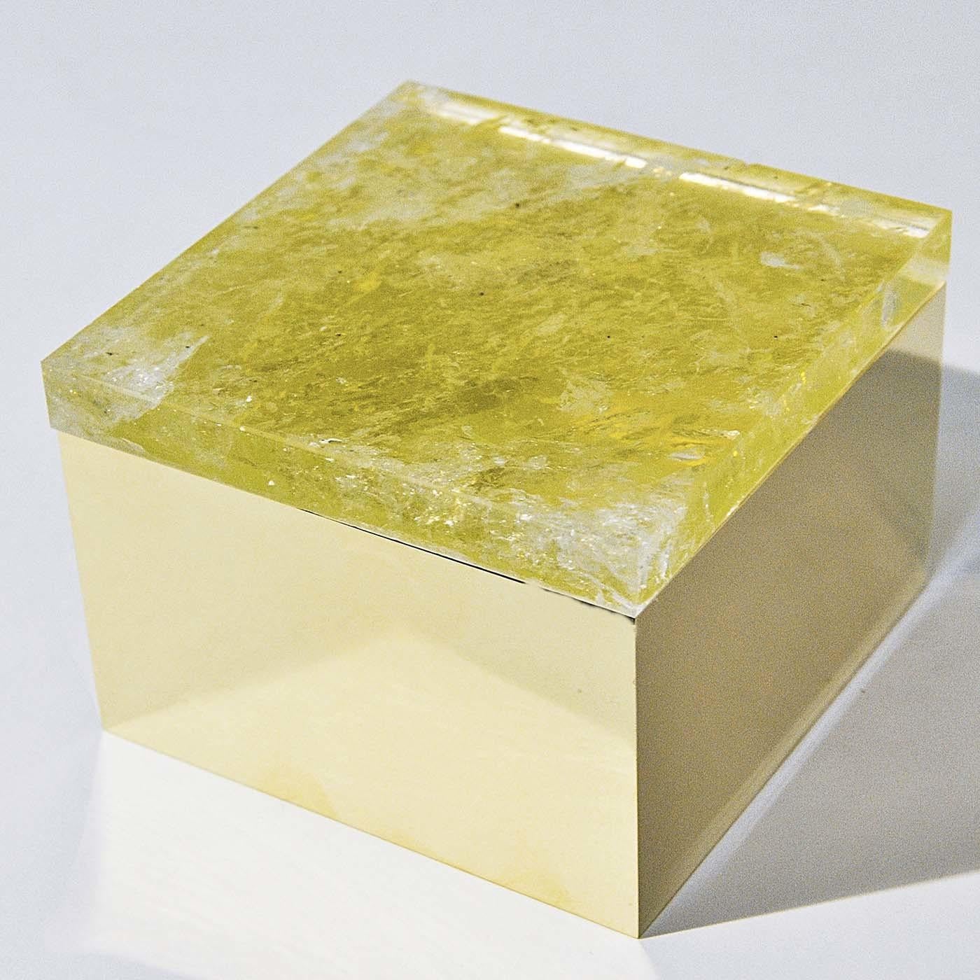 Bridging innovative craftsmanship with refined materials, this elegant box is a sculptural object of understated luxury. The square silhouette, made of polished gilt-plated brass, features a distinctive lid in vibrant yellow quartz. The rich yellow