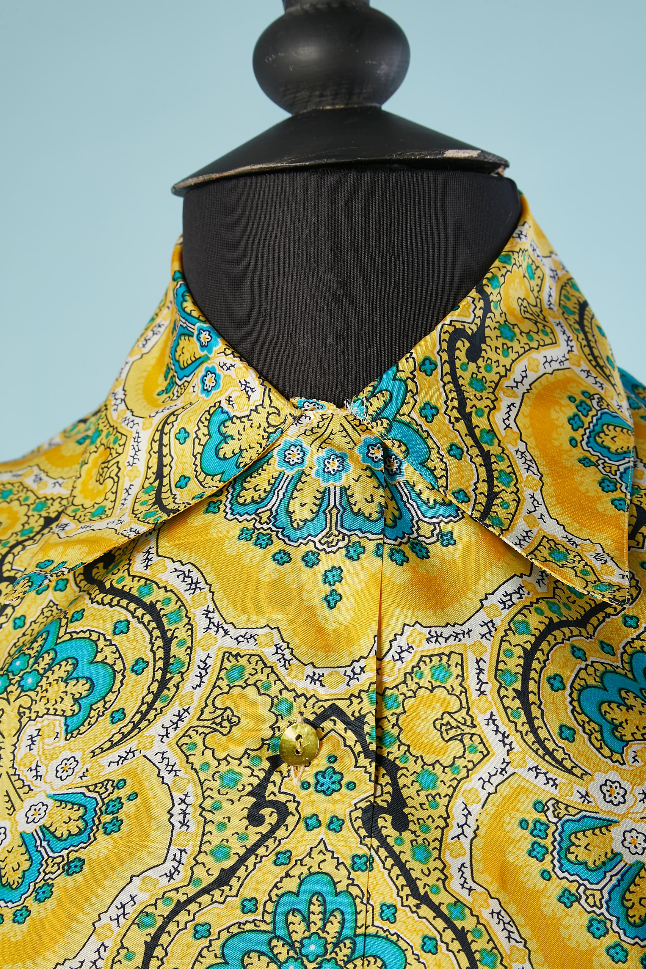 Yellow raw silk shirt with Paisley print. The top button is different from the others ( hidden under the collar) and the last button in the bottom is missing. Buttons and buttonhole on the cuff as well. 
SIZE 38 (Fr) but fit S 