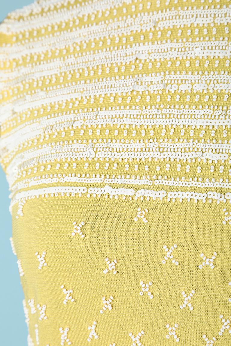 Yellow rayon jersey cocktail dress with beaded work. No lining. Zip in the middle back. 
SIZE 36/38 (Fr) S/M 