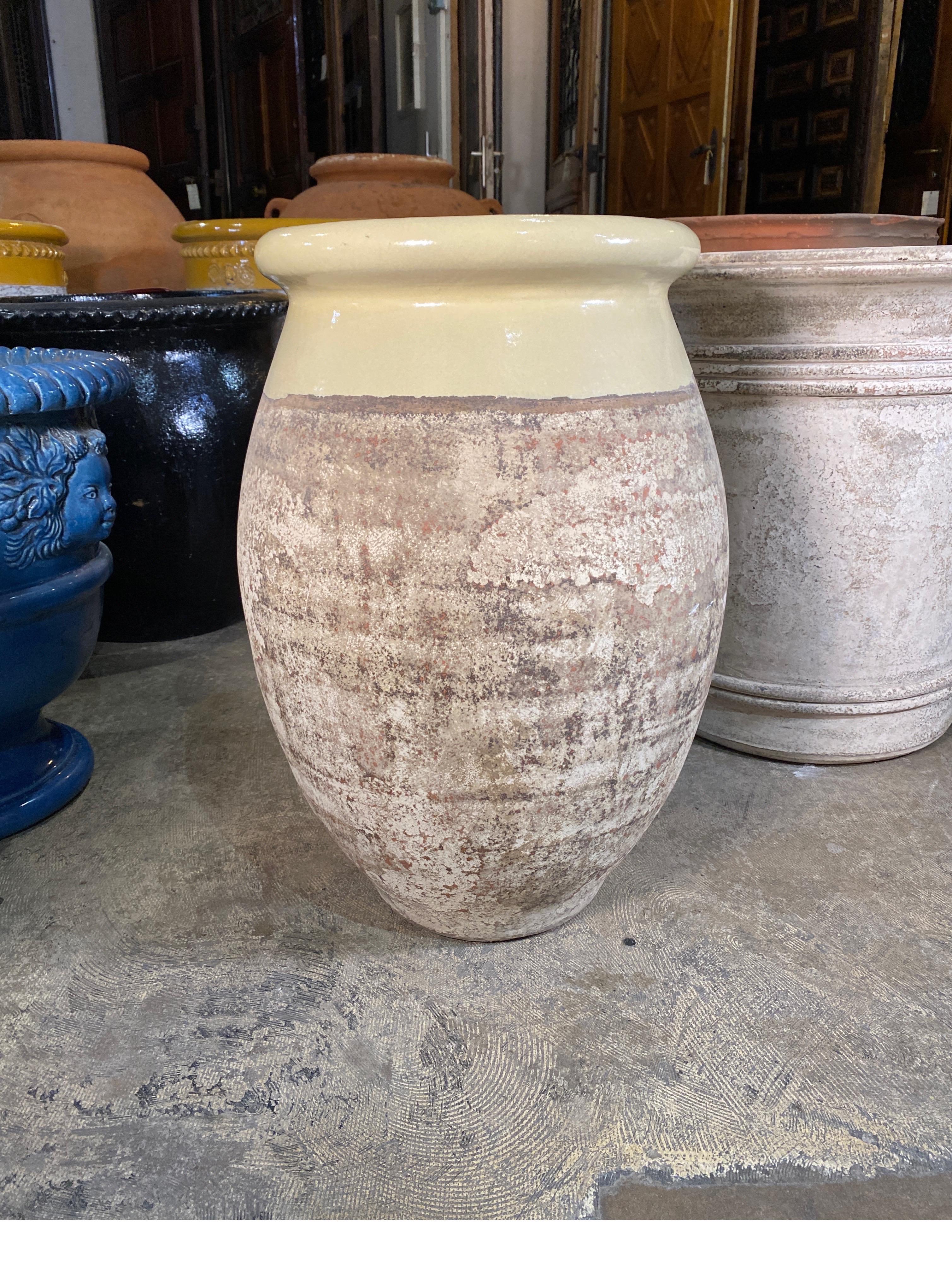 Yellow rimmed terra cotta urn handcrafted in France.
