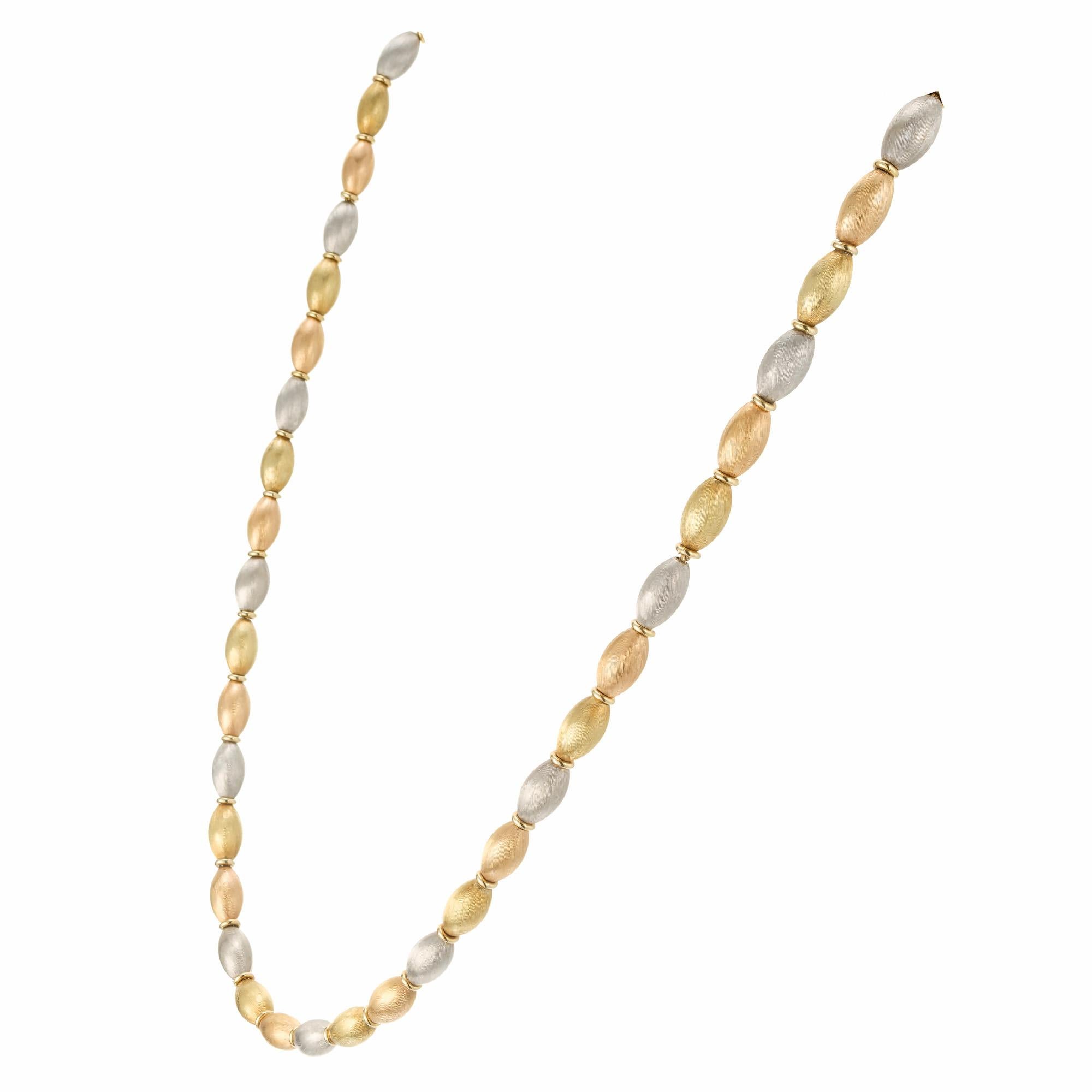 Textured yellow, rose and white gold bead necklace. 18k gold Oval bead's with 18k yellow gold round spacers. 18.5 inches.  

18k yellow gold 
Stamped: 18k
Hallmark: Italy
29.6 grams
Total length: 18.5 Inches
Width: 4.9mm
Thickness/depth: 4.9mm

