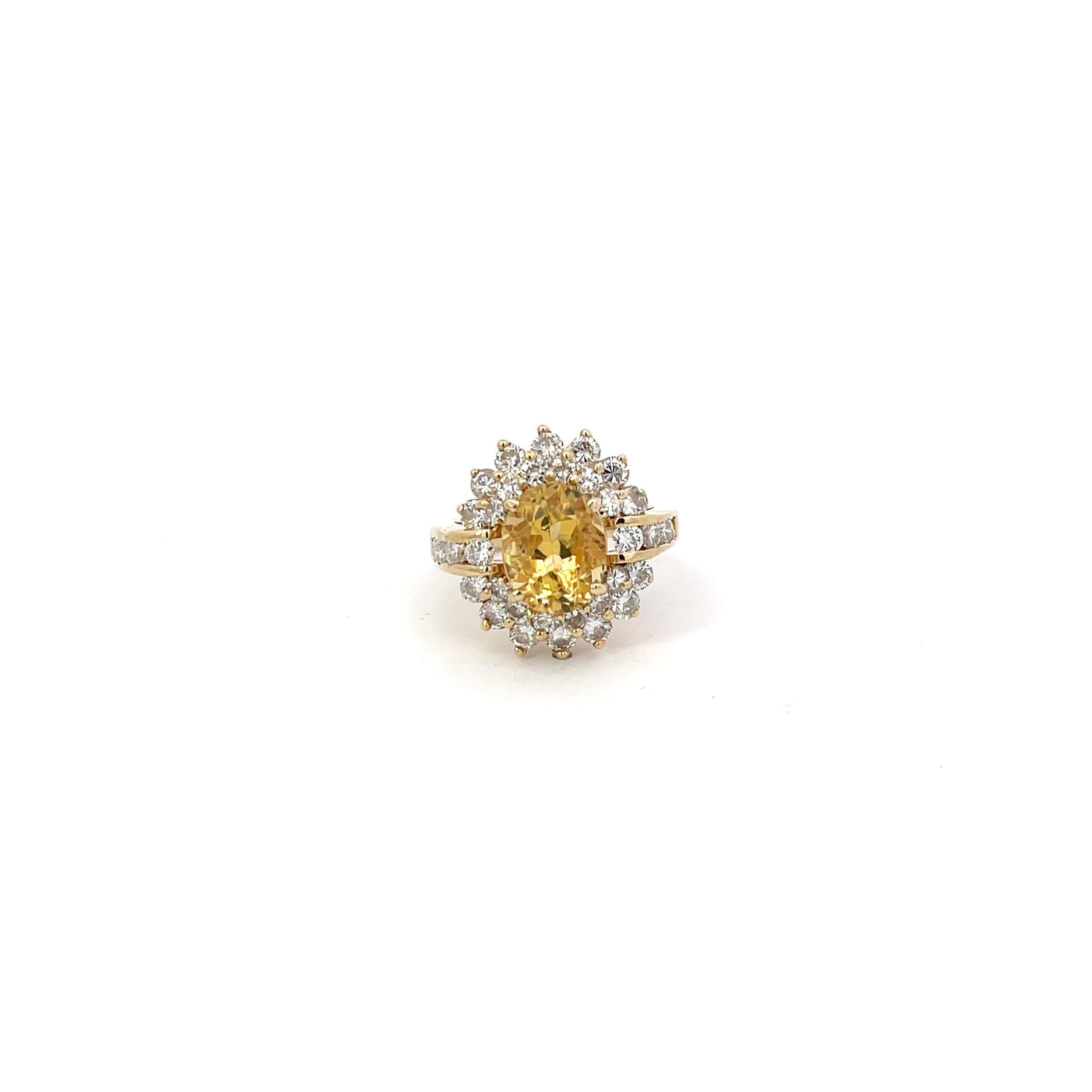 Yellow Sapphire and Diamond Ring in 14K Yellow Gold. The ring features an oval cut 2.50ct yellow sapphire, accented by 1.40ctw of brilliant round diamonds. The ring is size 6 and weighs 6.8 grams.