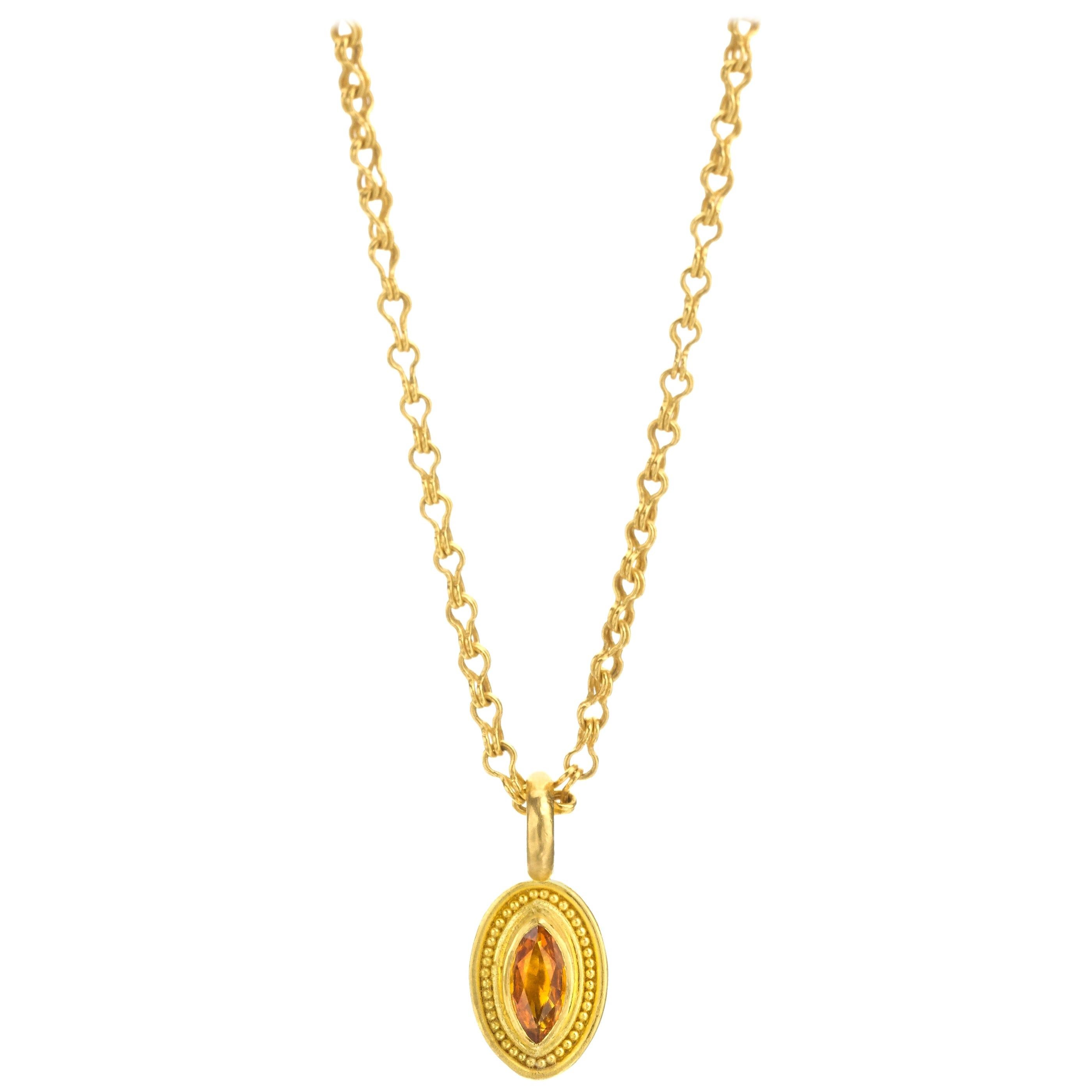 Vibrant marquise cut golden-yellow sapphire pendant/ charm. Set in 22 karat gold with delicate granulation. Pendant is on a mini sailor's knot chain in 22 karat gold (sold separately see storefront). Entirely made by hand in New York City. 

