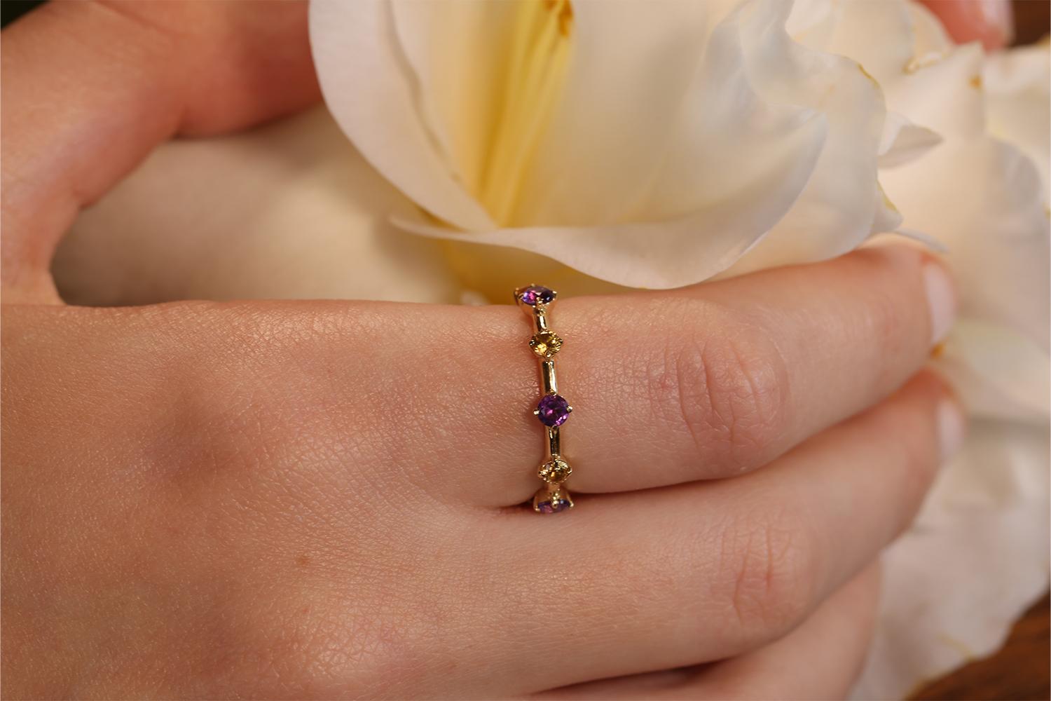 This is a beautifully made custom ring that is one of a kind, it is literally 1 of 1. The ring features 5 yellow sapphire stones and 5 purple amethyst stones and the two colors are very complimentary. Made by T Makowski Company in North America the