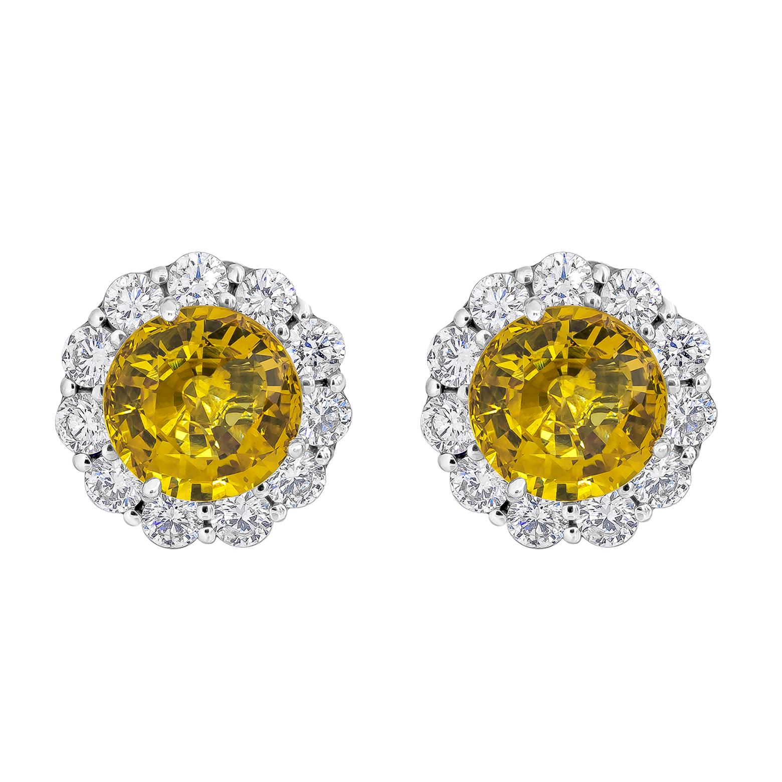 Showcasing two color-rich brilliant round cut yellow sapphires weighing 6.94 carats total, surrounded by a single row of round brilliant diamonds weigh 2.12 carats total. Beautifully set in a polished platinum mounting.

Style available in different