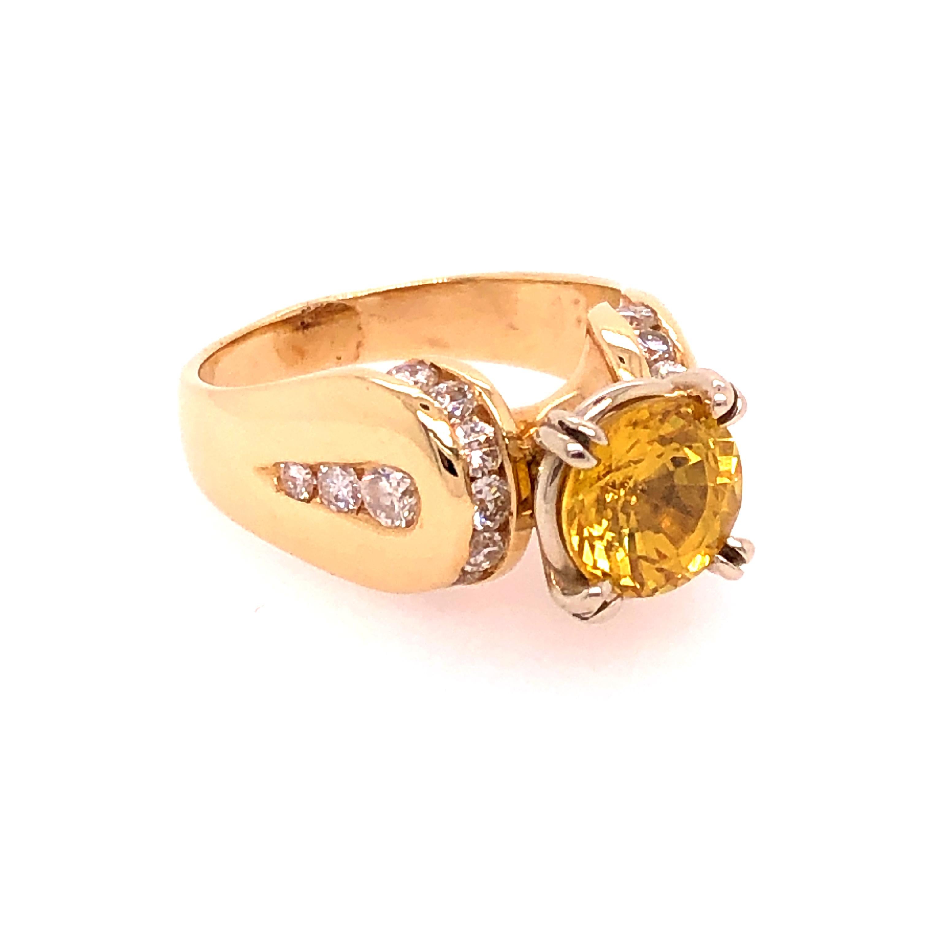 Character and substance, that is how I would define the design of this Yellow Sapphire and Diamond ring. We start with a well cut 2.18 CT round yellow sapphire set into a 14K white gold head. The head is set into the 14K yellow gold ring. The