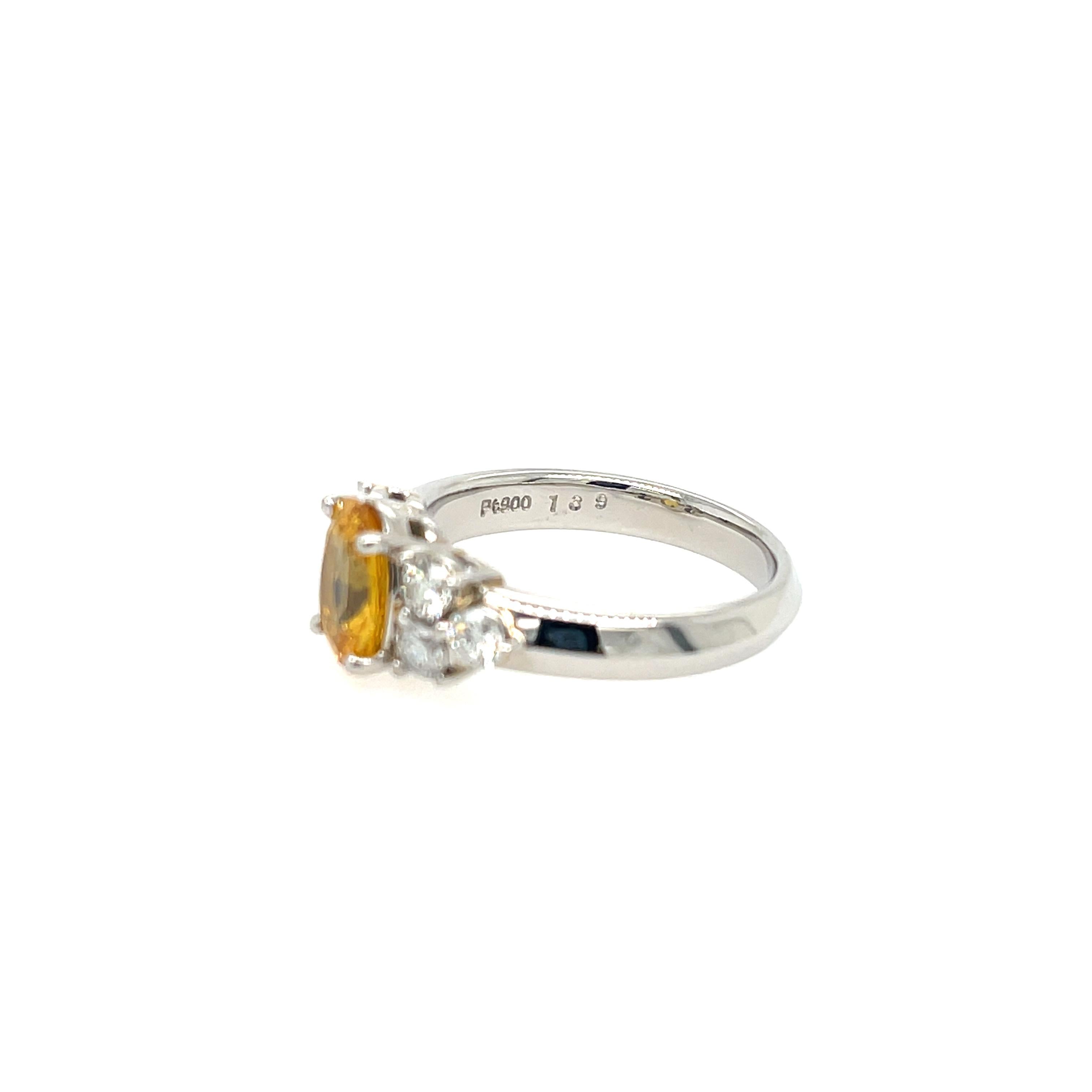 Estate Yellow Sapphire and Diamond Ring in Platinum. The ring features a 1.39ct oval yellow sapphire and 0.55ctw of round diamonds. Size 6.