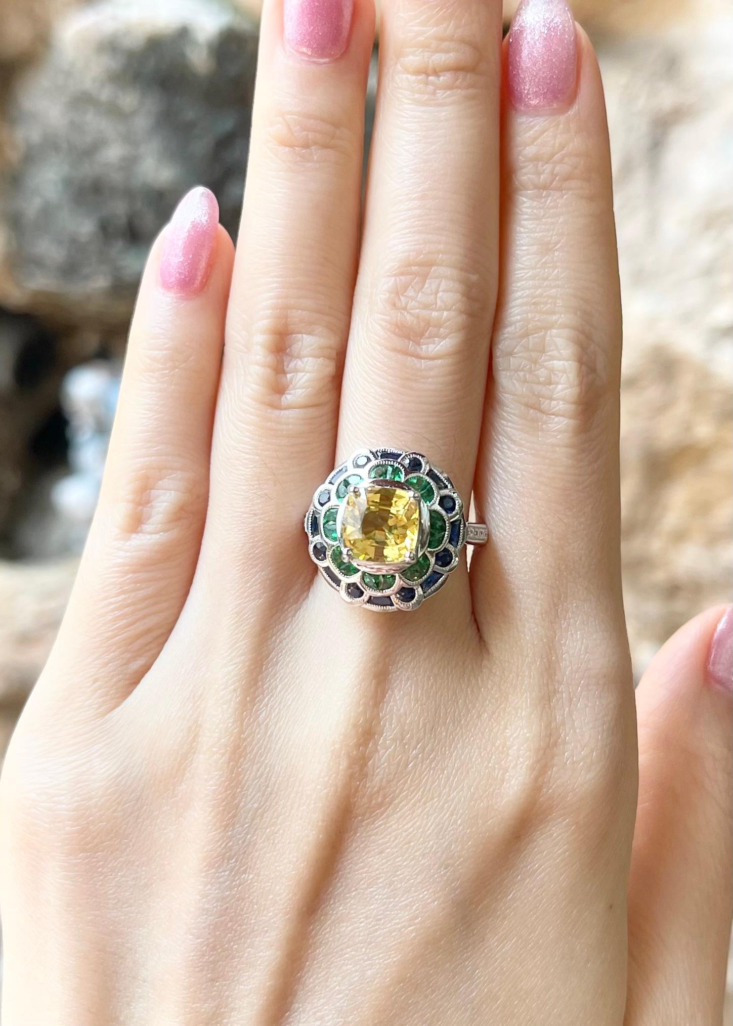 Yellow Sapphire 3.0 carats, Blue Sapphire 1.24 carats, Tsavorite 0.69 carat and Diamond 0.90 carat Ring set in 18K White Gold Settings

Width:  1.7 cm 
Length: 1.7 cm
Ring Size: 54
Total Weight: 10.92 grams

