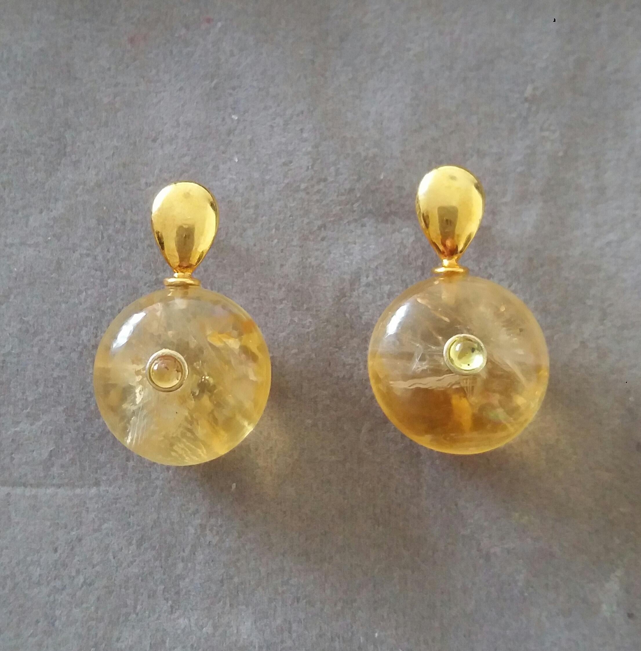 Simple chic stud earrings with a pair of Flat Drop shape 14 Kt. yellow gold tops and in the lower parts 2 Round Plain Wheel Shape Citrines  16 mm .in diameter with a small round Yellow Sapphires cabs in the center
In 1978 our workshop started in