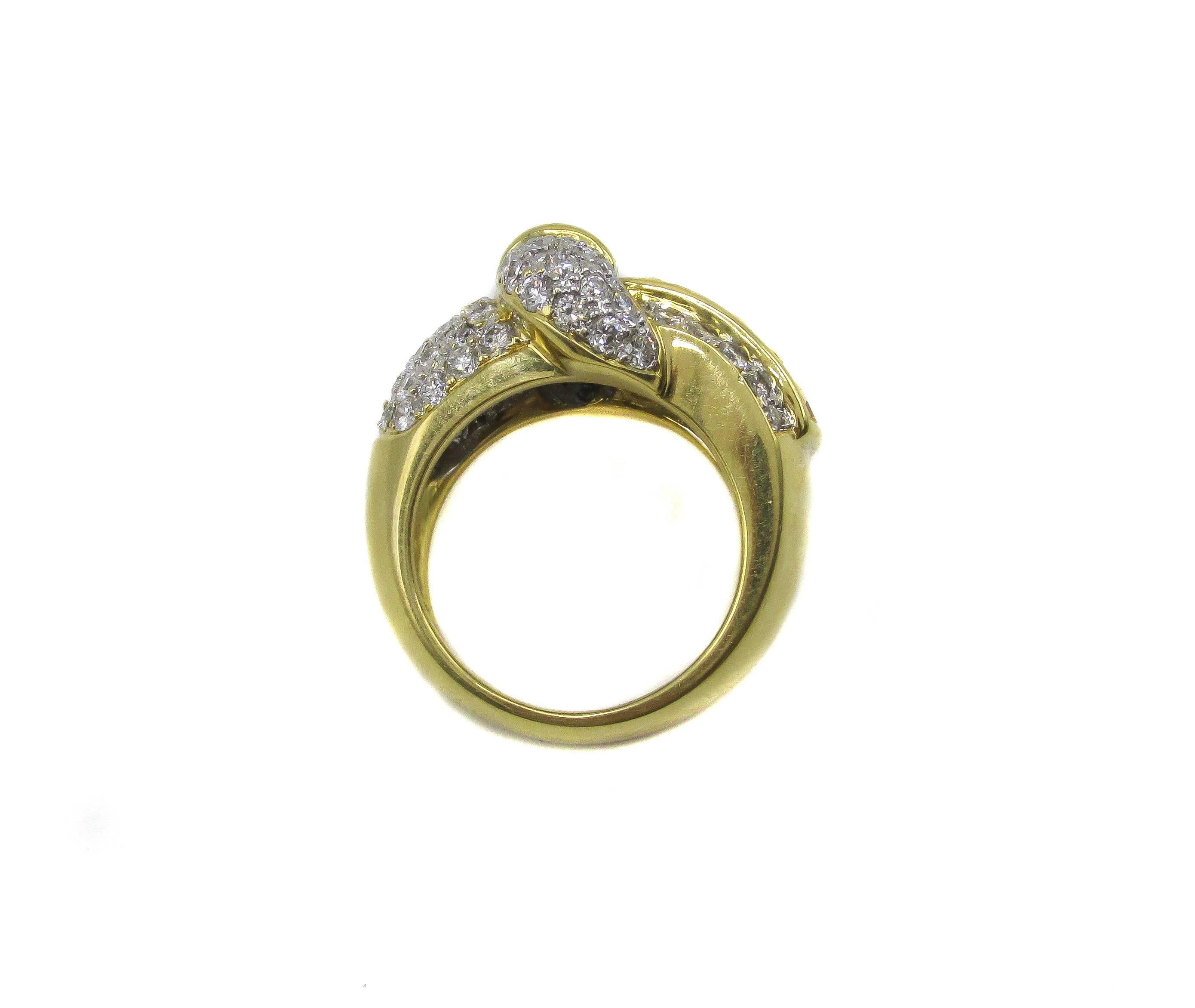 Stunning 18 karat yellow gold diamond and yellow sapphire ring designed as a belt buckle. This amazingly crafted ring is pave set with 79 round brilliant cut diamonds and 4 channel set baguette cut diamonds. 18 vivid orangey yellow square emerald