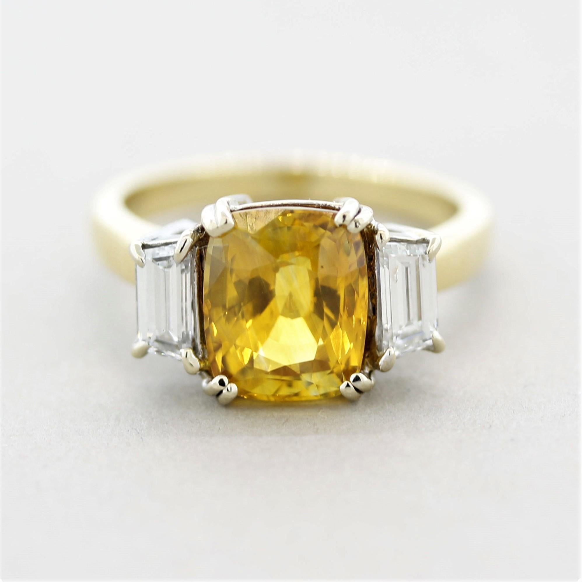 A classic 3-stone ring featuring a big and bright yellow sapphire! It weighs 4.34 carats and is cut into a beautiful cushion-shape. It is accented by 2 baguette-cut diamonds weighing a total of 0.50 carats. Made in a two-tone 18k gold design, the