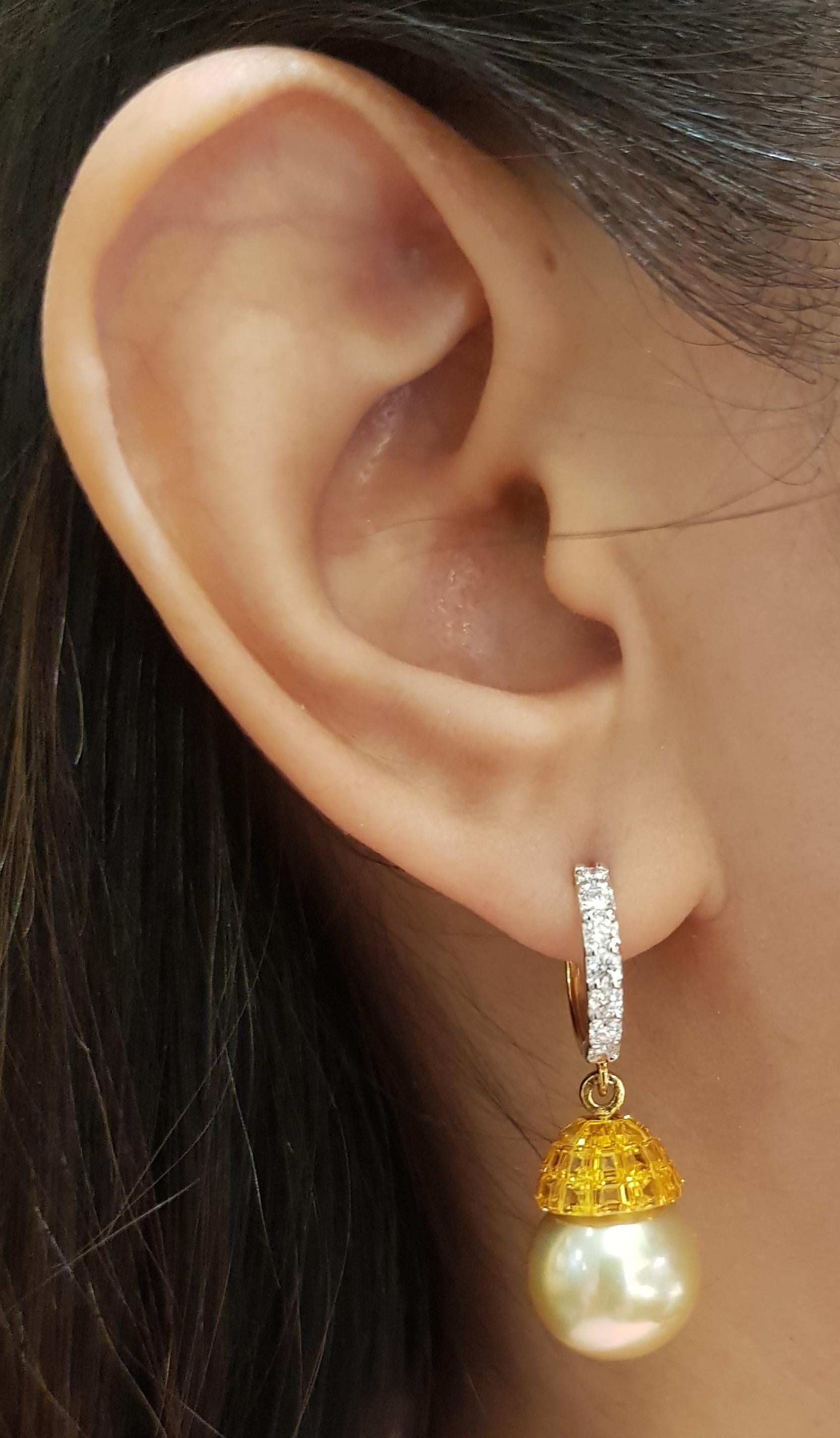 Yellow Sapphire 8.80 carats, Diamond 0.55 carat and South Sea Pearl Earrings set in 18 Karat Gold Settings

Width:  1.1 cm 
Length: 3.6 cm
Total Weight: 12.1  grams

South Sea Pearl: 12.6 mm

