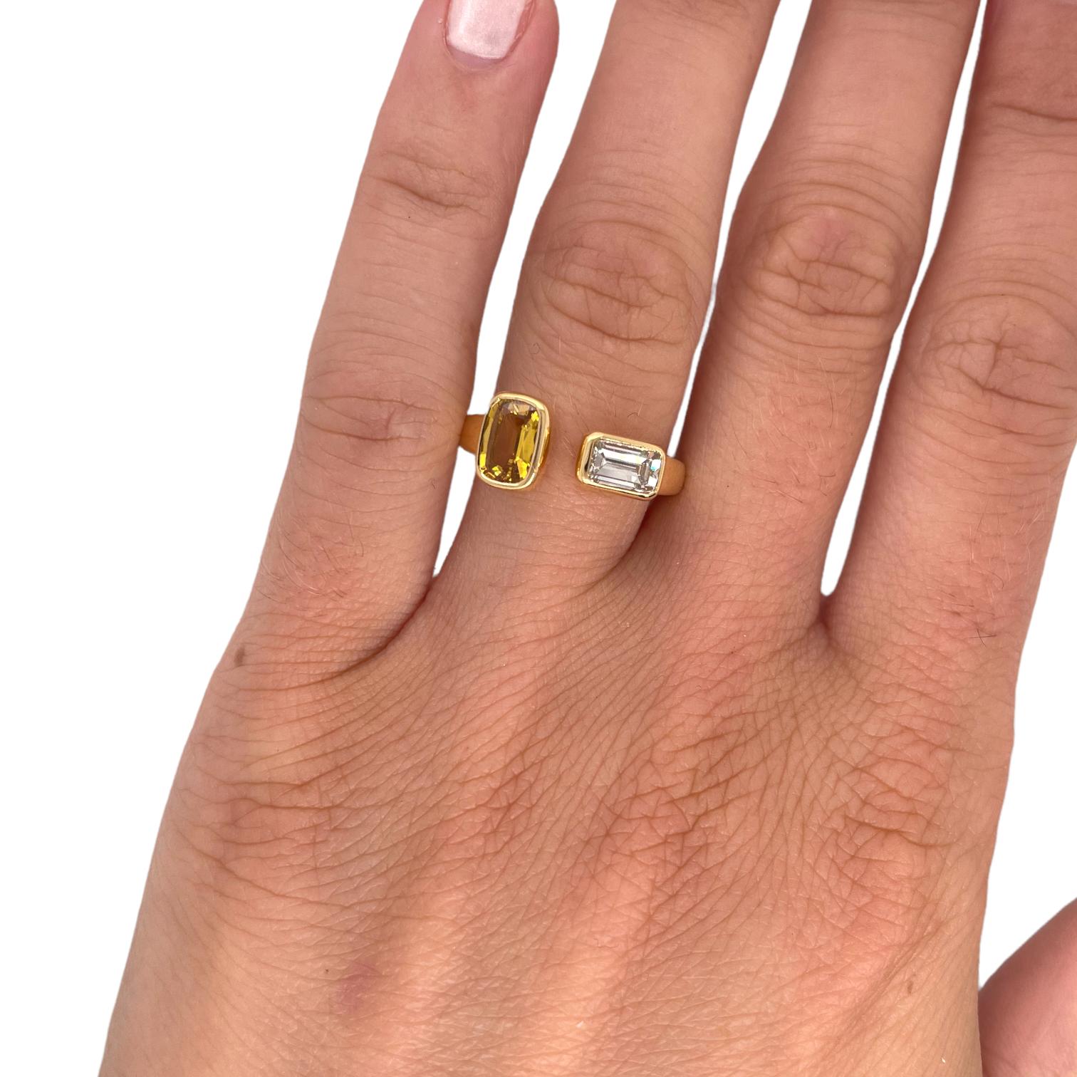 Ring contains one cushion cut yellow sapphire and one elongated emerald cut diamond, 
Emerald cut diamond is H in color and SI1 in clarity.  Stones are mounted in handmade bezel settings in a bypass style ring. Ring is a size 6 and can be resized to