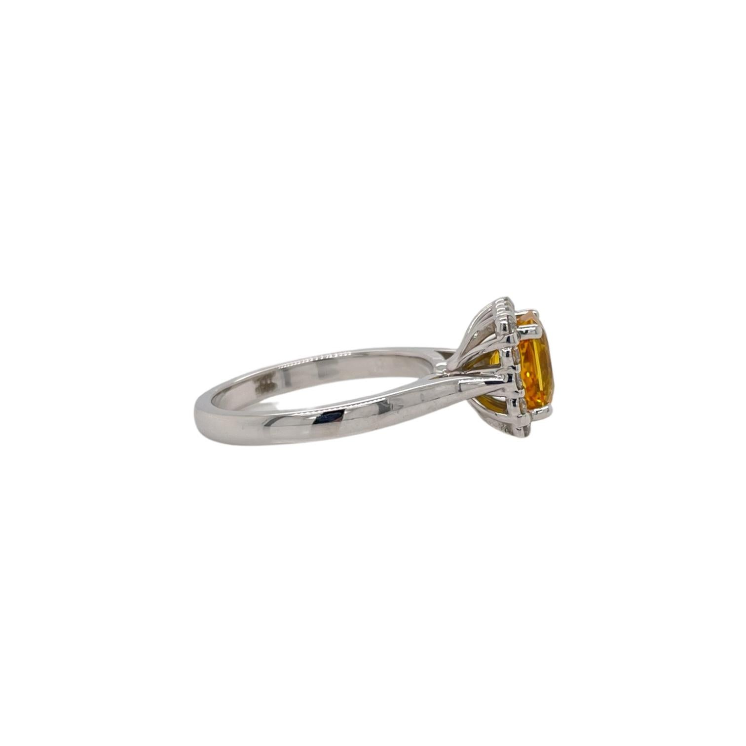 Ring contains one radiant cut yellow sapphire, 2.13ct and 18 round brilliant diamonds surrounding,  0.21tcw. Diamonds are G in color and VS2 in clarity. Stones are mounted in a handmade prong setting in 18k gold. Ring is a size 6 and can be resized