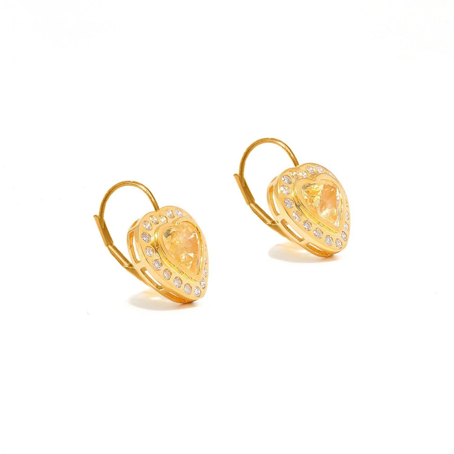 
Luminous Yellow Sapphires of exceptional luster and clarity in a modern bezel setting whose beauty is further enhanced by Brilliant Cut White Diamonds set into perfect, heart-shaped drop earrings of 18 Karat Gold.

- Natural Yellow Sapphires weight