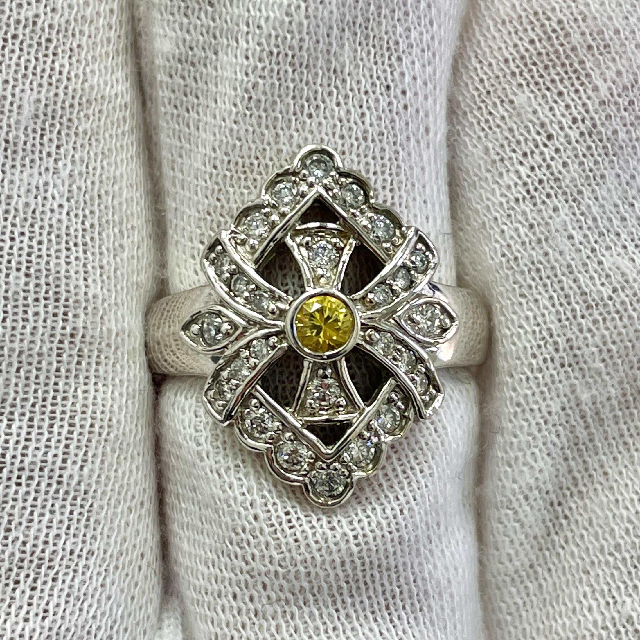 This is a round, sunny yellow sapphire mounted in a 14K white gold ring with 0.46Ct of brilliant white diamonds. Suitable for any occasion!