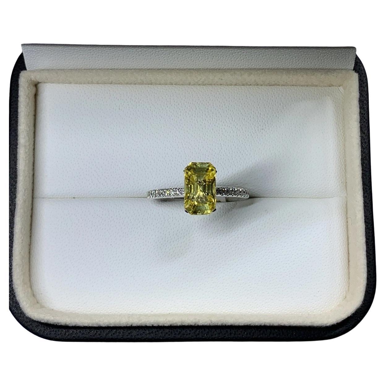 Yellow sapphire emerald diamonds engagement ring in platinum.