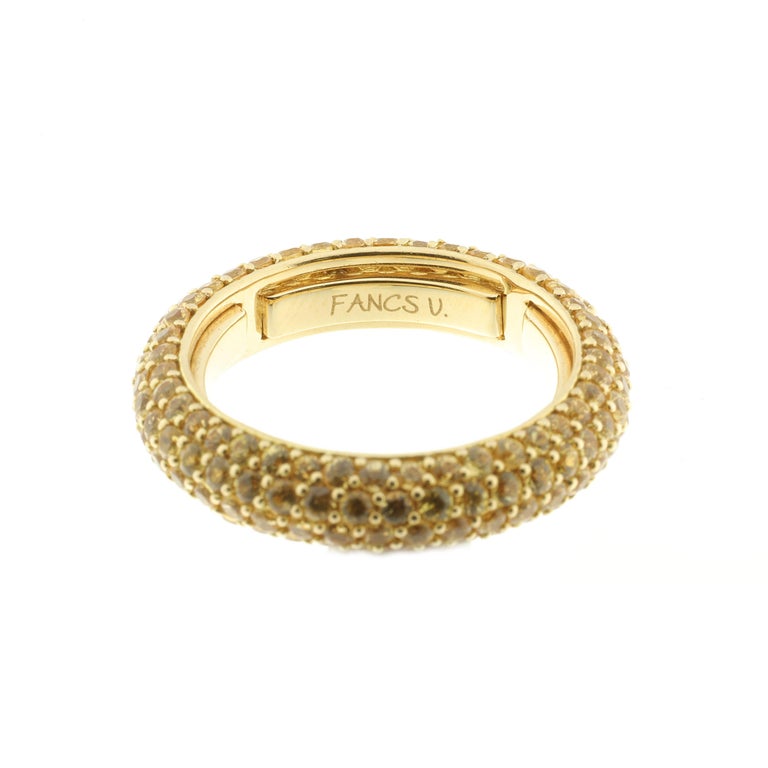 This 18-karat yellow gold and yellow sapphire infinity ring is luxuriously sleek and modern.

The ring is fabulous to wear: Inside the band are a series of sprung sizers which comfortably fit the ring to your finger. 

The ring is set with 3.60