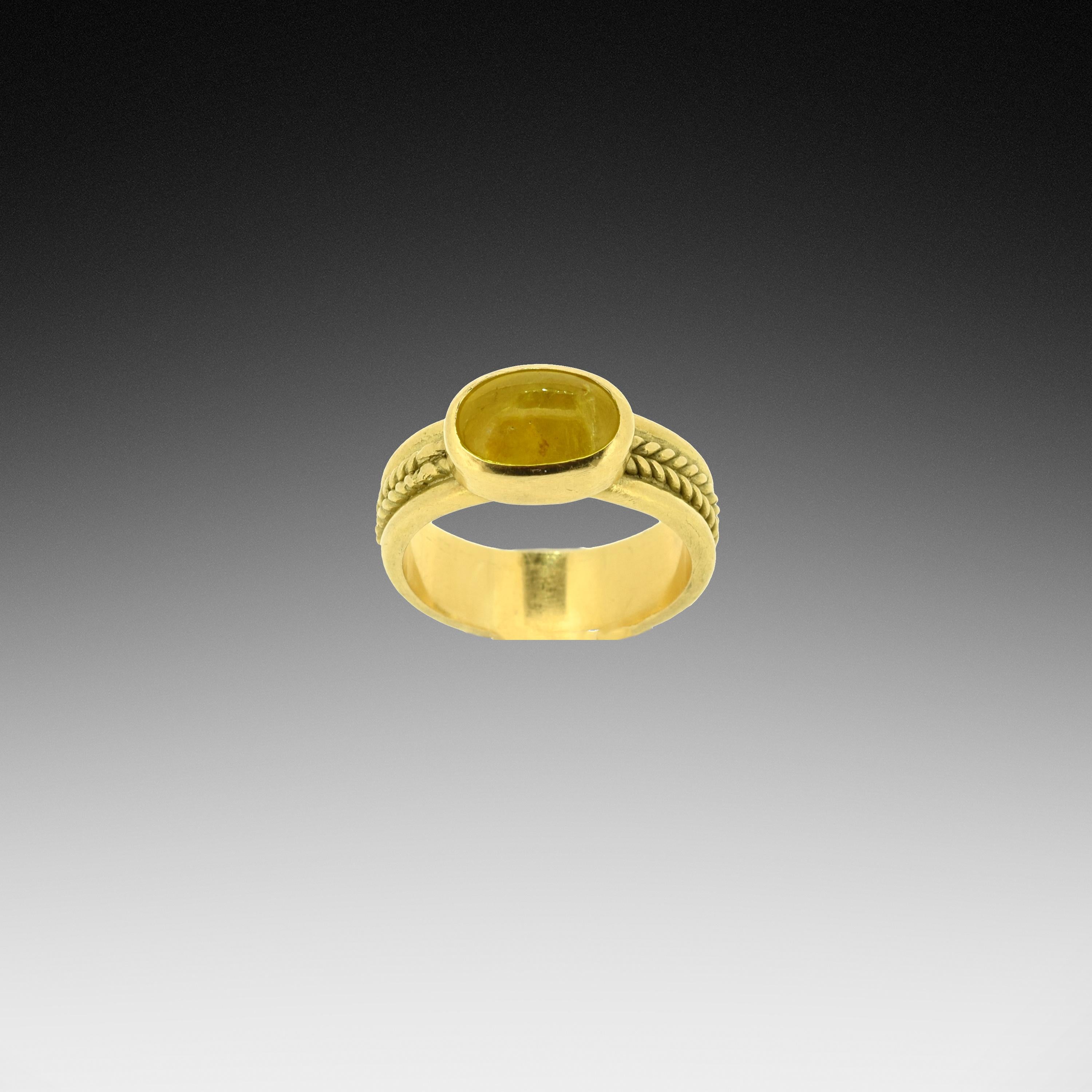 A 3.38 carat smooth Yellow Sapphire from Sri Lanka subtly adorns this 18K rope band.  All handmade and one of a kind.  The ring size is 6.
Due to the nature of this band, the ring cannot be re-sized.

Note: Photos 4 & 5 show this ring stacked with a