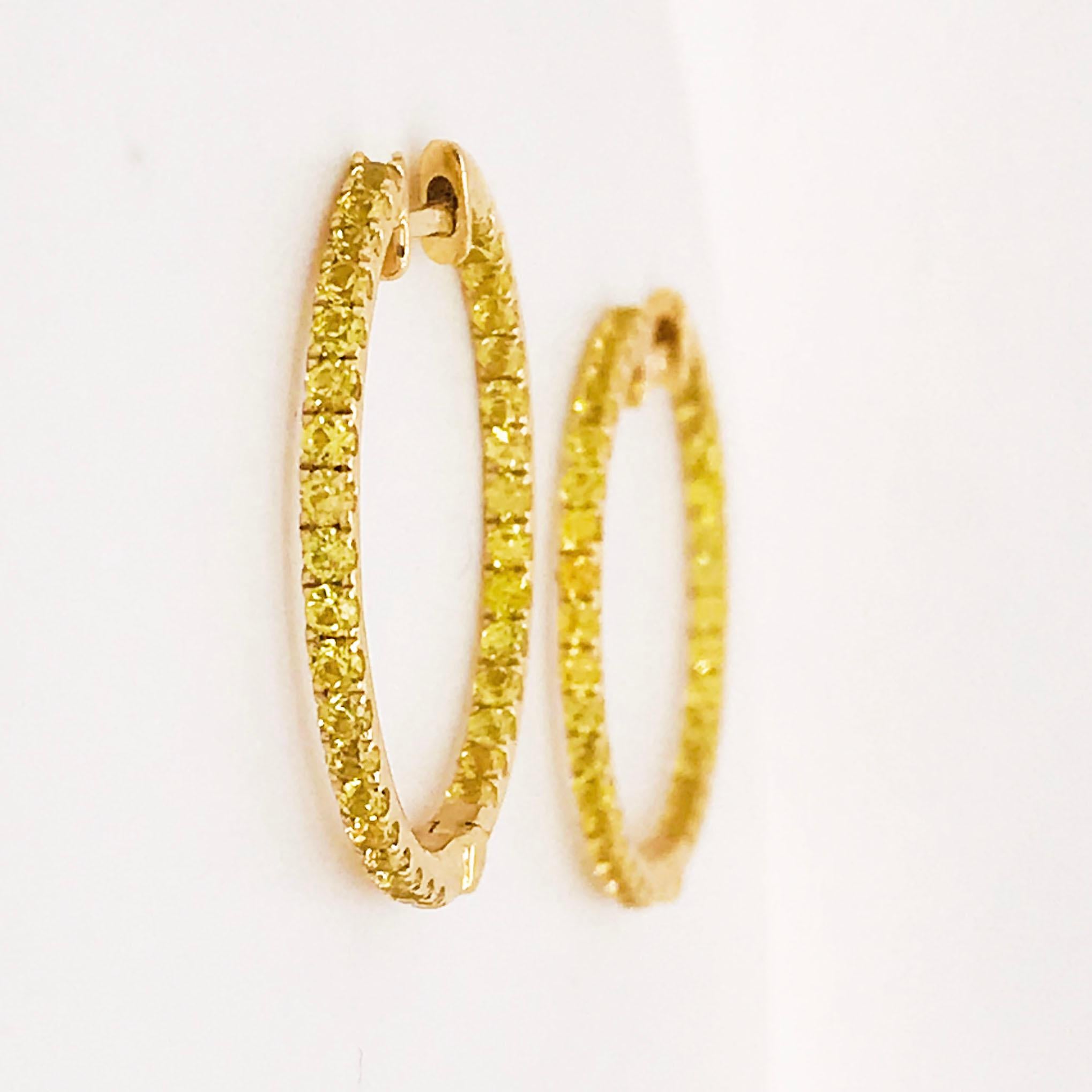 Yellow sapphire hoops are the modern hoop design of 2020! These bold hoops are made in 14 karat yellow gold with genuine, yellow sapphire gemstones. The hoop earrings have an inside-out design that allows the sapphires to be seen from the front as