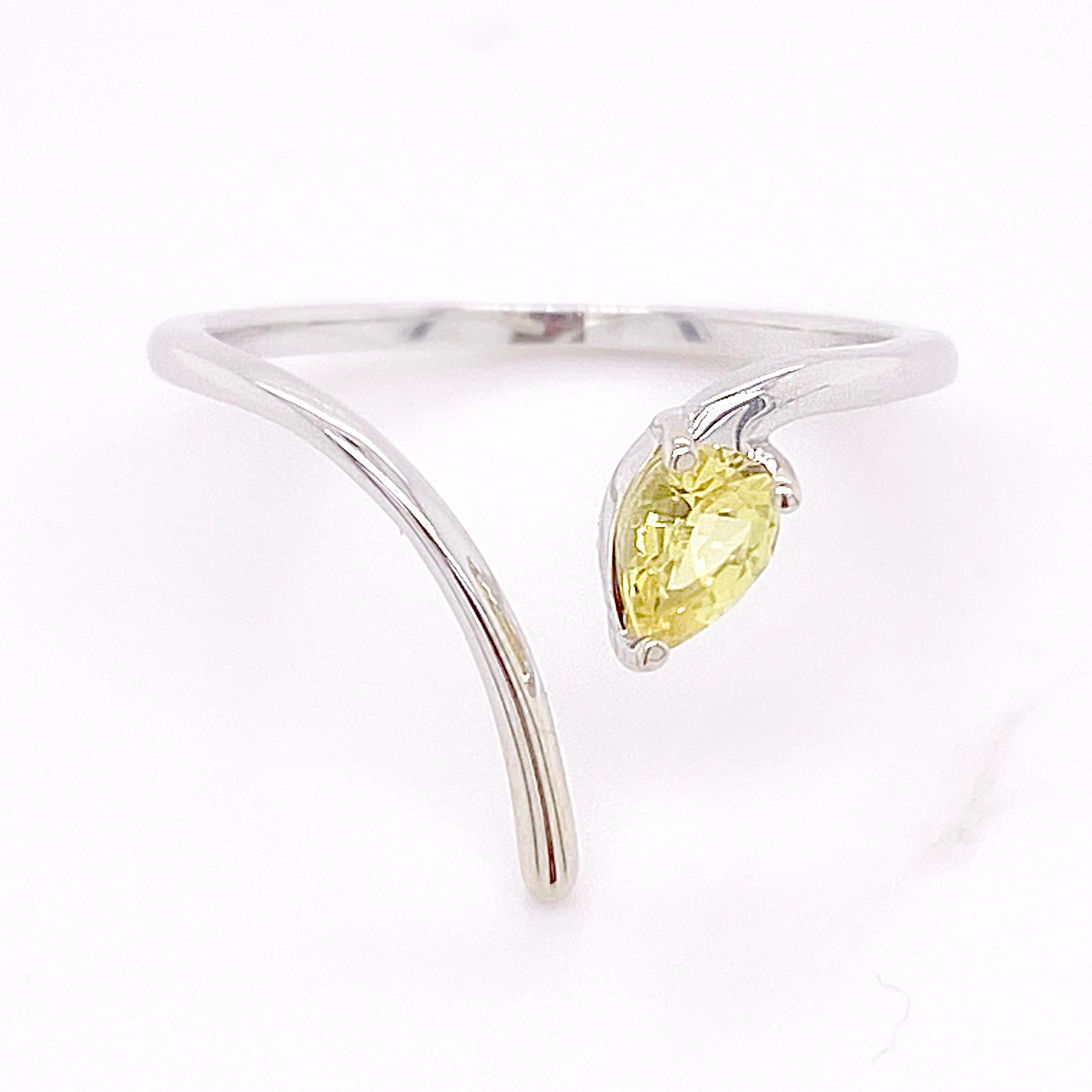 This unique yellow sapphire is a pear shaped gemstone that weighs 1/2 carat. The negative space design looks fab on any finger. The 14 karat white gold is very shiny and high polished. 14 karat white gold is 40 times harder than sterling silver and