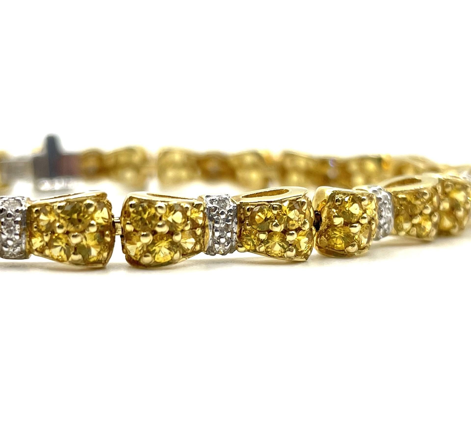 An Beautiful Bow Tie Bracelet set with natural yellow sapphires and natural white diamonds in 18kt yellow gold.

144 natural yellow sapphires weighing 6.00ct total weight

36 natural white diamonds weighing 0.30ct total weight

18kt yellow gold, 18