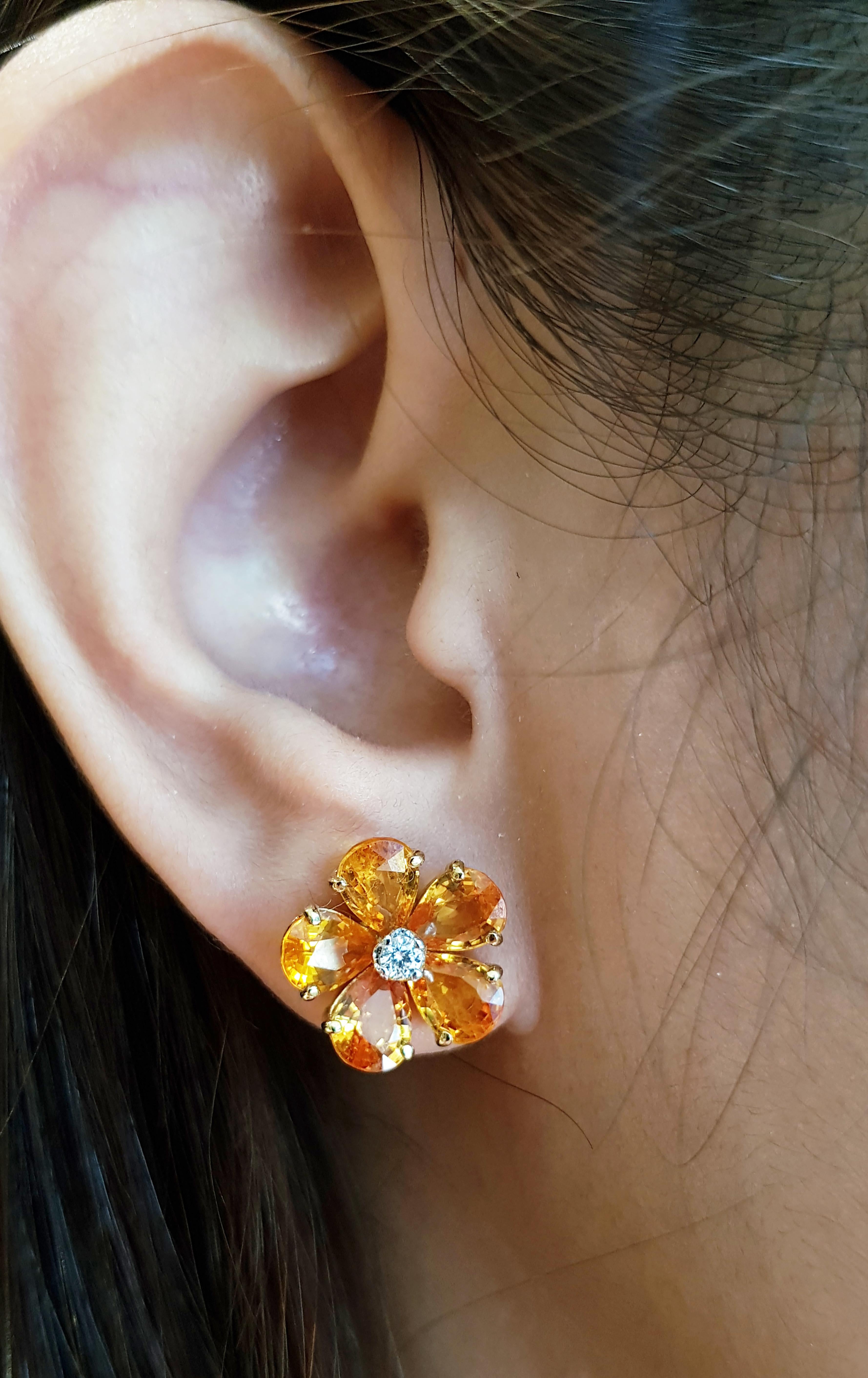 Yellow Sapphire 9.53 carats with Diamond 0.12 carat Earrings set in 18 Karat Gold Settings

Width:  1.4 cm 
Length: 1.4 cm
Total Weight: 6.25 grams

