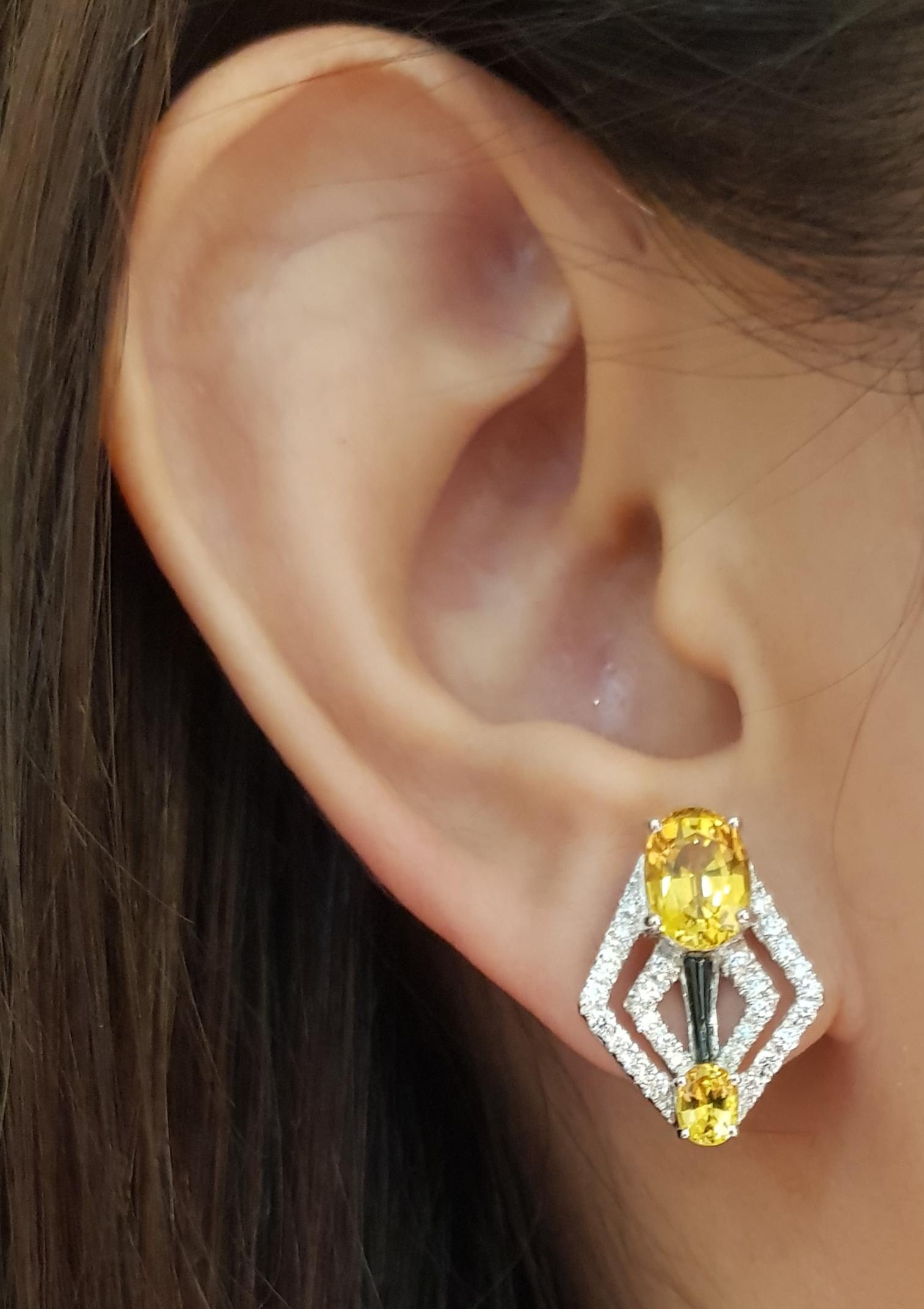 Yellow Sapphire 4.80 carats with Diamond 0.52 carat Earrings set in 18 Karat White Gold Settings

Width:  1.3 cm 
Length:  2.0 cm
Total Weight: 9.08 grams

