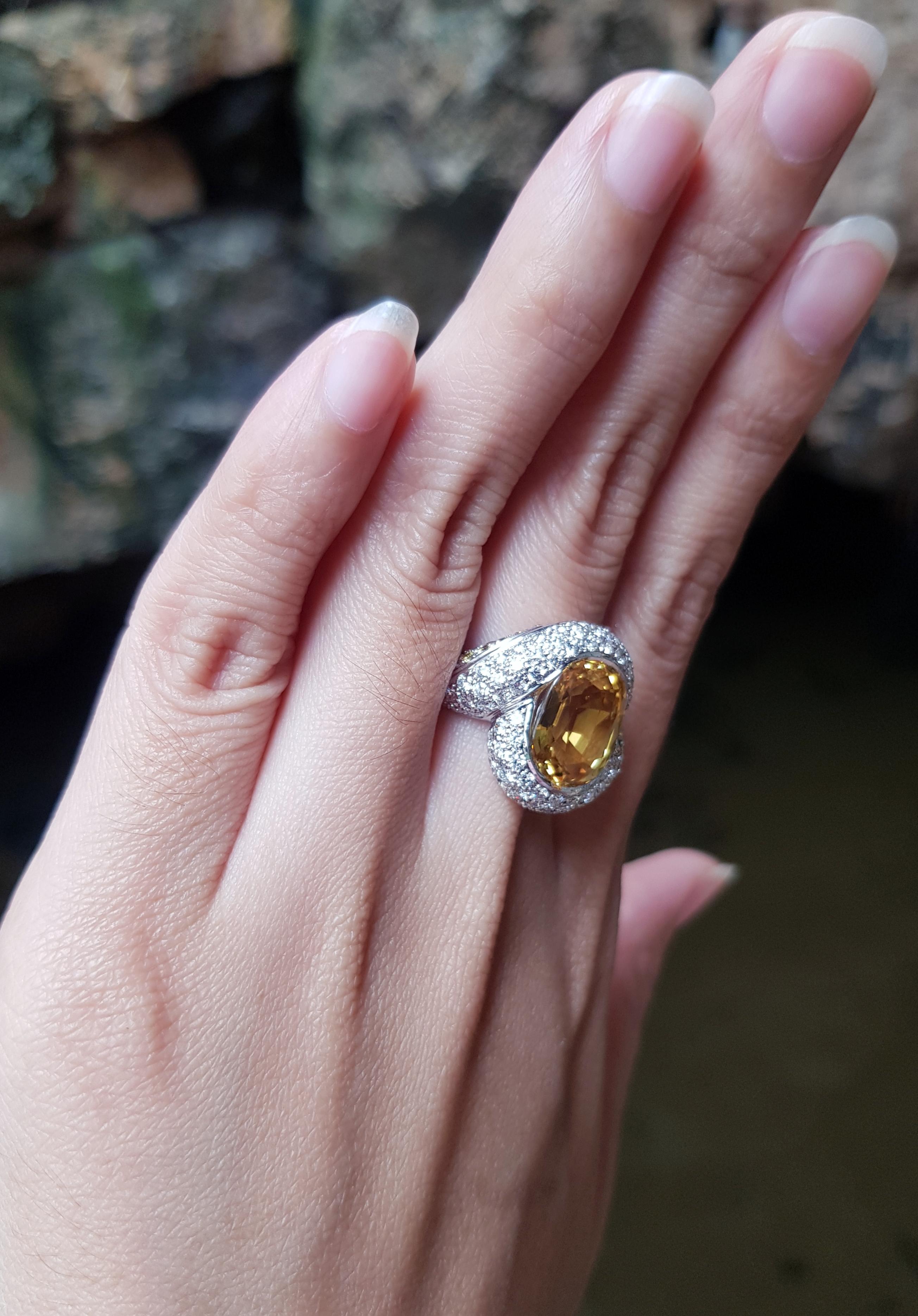 Oval Cut Yellow Sapphire with Diamond Ring Set in 18 Karat White Gold Settings For Sale