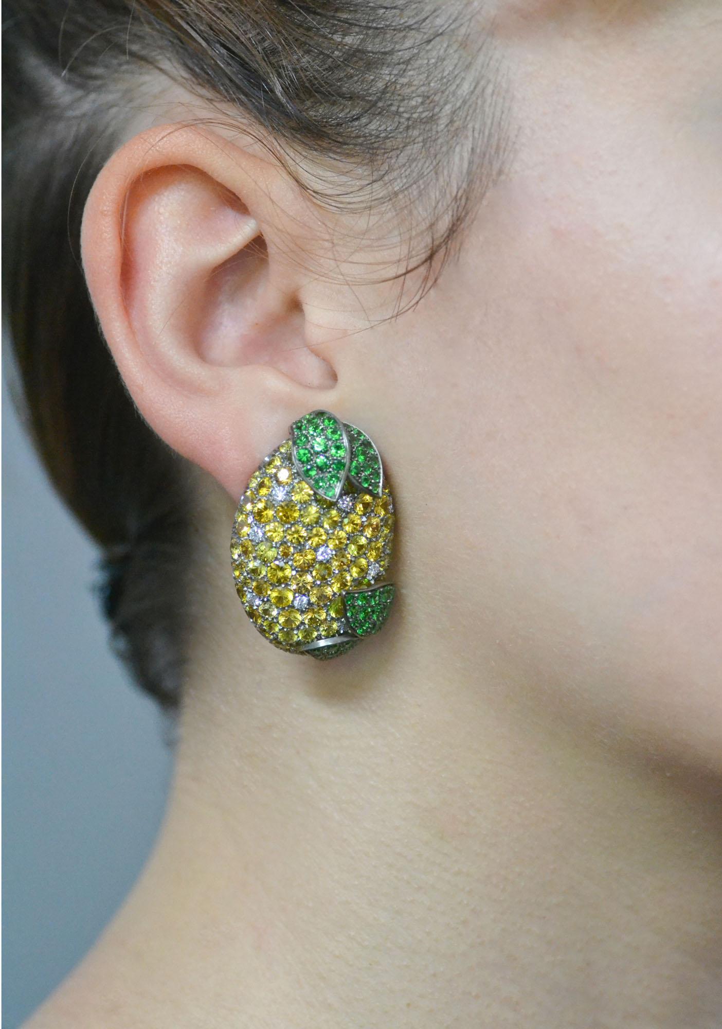 Handcrafted in Italy, the Lemon earrings are realized in  titanium, then they are extremely light.
Set in yellow sapphires and diamonds, are decorated with leaves set in vivid green tsavorite.  

18 KT  yellow gold grams 3.30
n. 20 diamonds total ct