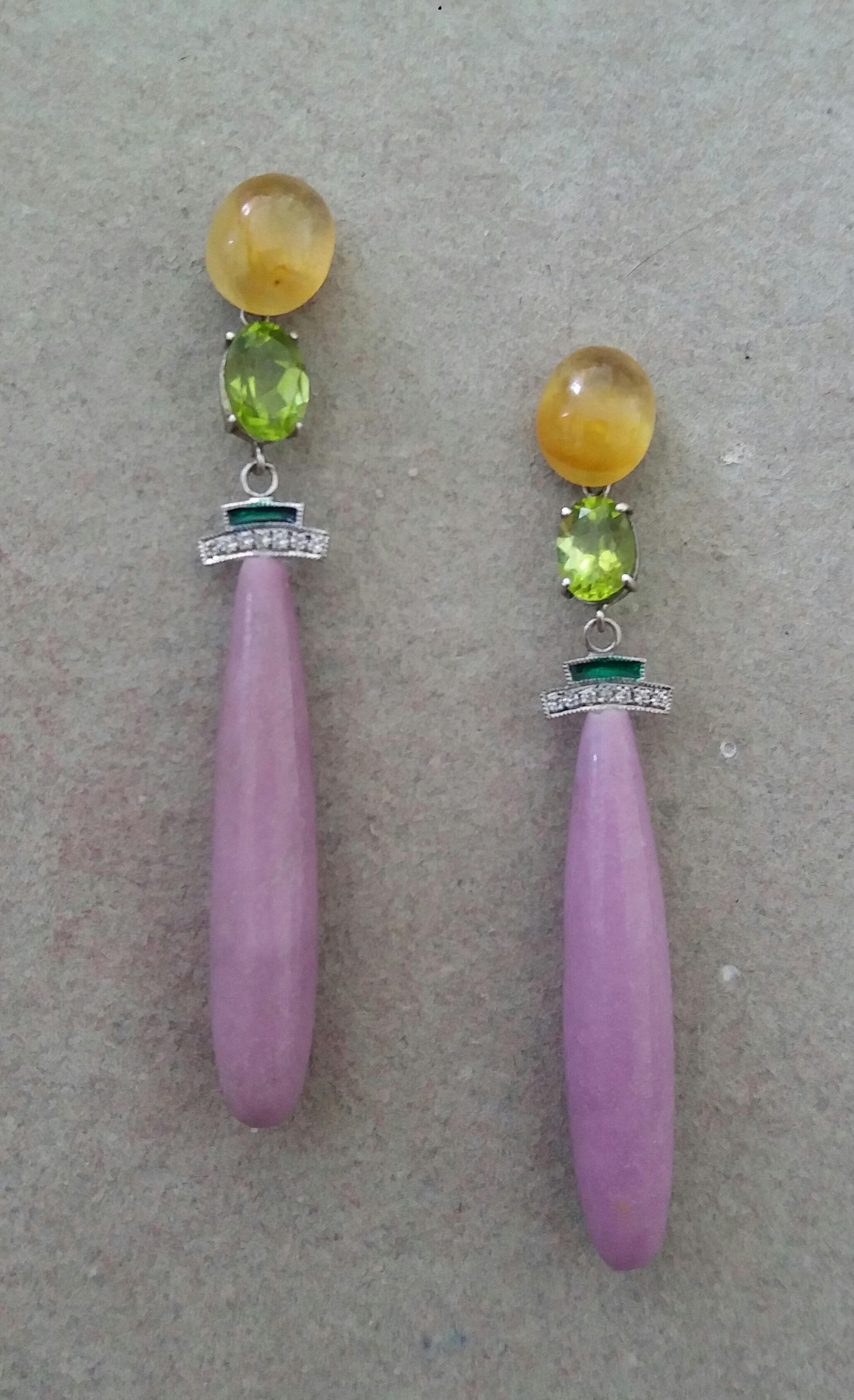 A pair of Art Deco style earrings, the upper part with 2 oval Yellow Sapphires cabochons 8 mm x 10 mm that support 2 oval faceted Peridot 6mmx8mm and 2 elements in white gold, diamonds and green enamel, while the lower parts are composed of 2