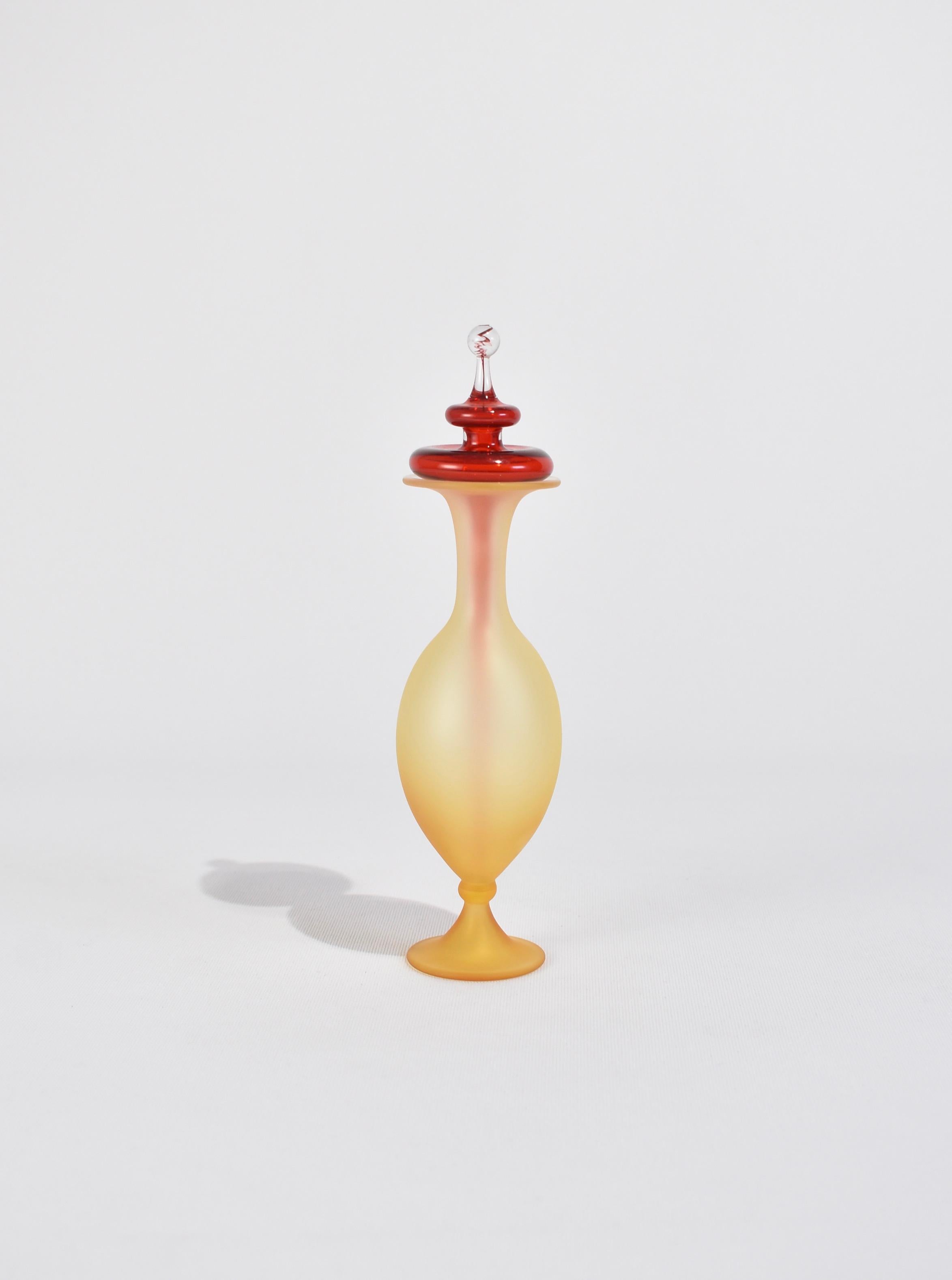 Stunning Vintage perfume bottle in yellow with a satin finish and a sculptural red glass stopper.