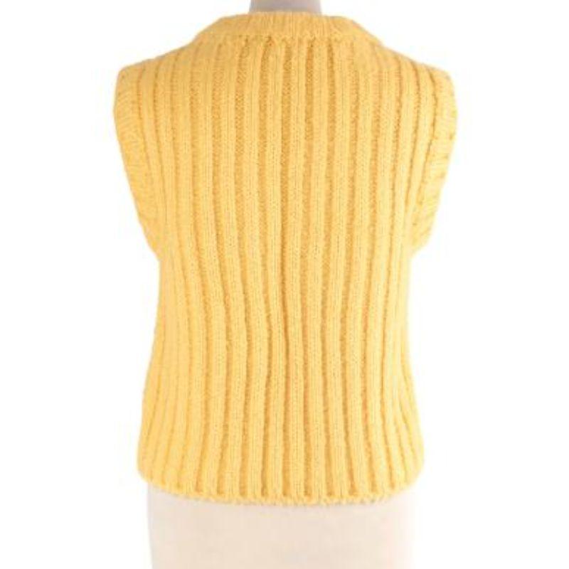 Cecilie Bahnsen yellow silk cable knit vest
 
 
 
 - Bright primrose yellow, soft candle silk yarn
 
 - Round ribbed neck, sleeveless with cable knit body
 
 - Boxy cut, perfect for layering 
 
 
 
 Materials:
 
 100% Silk 
 
 
 
 Made in Romania 
