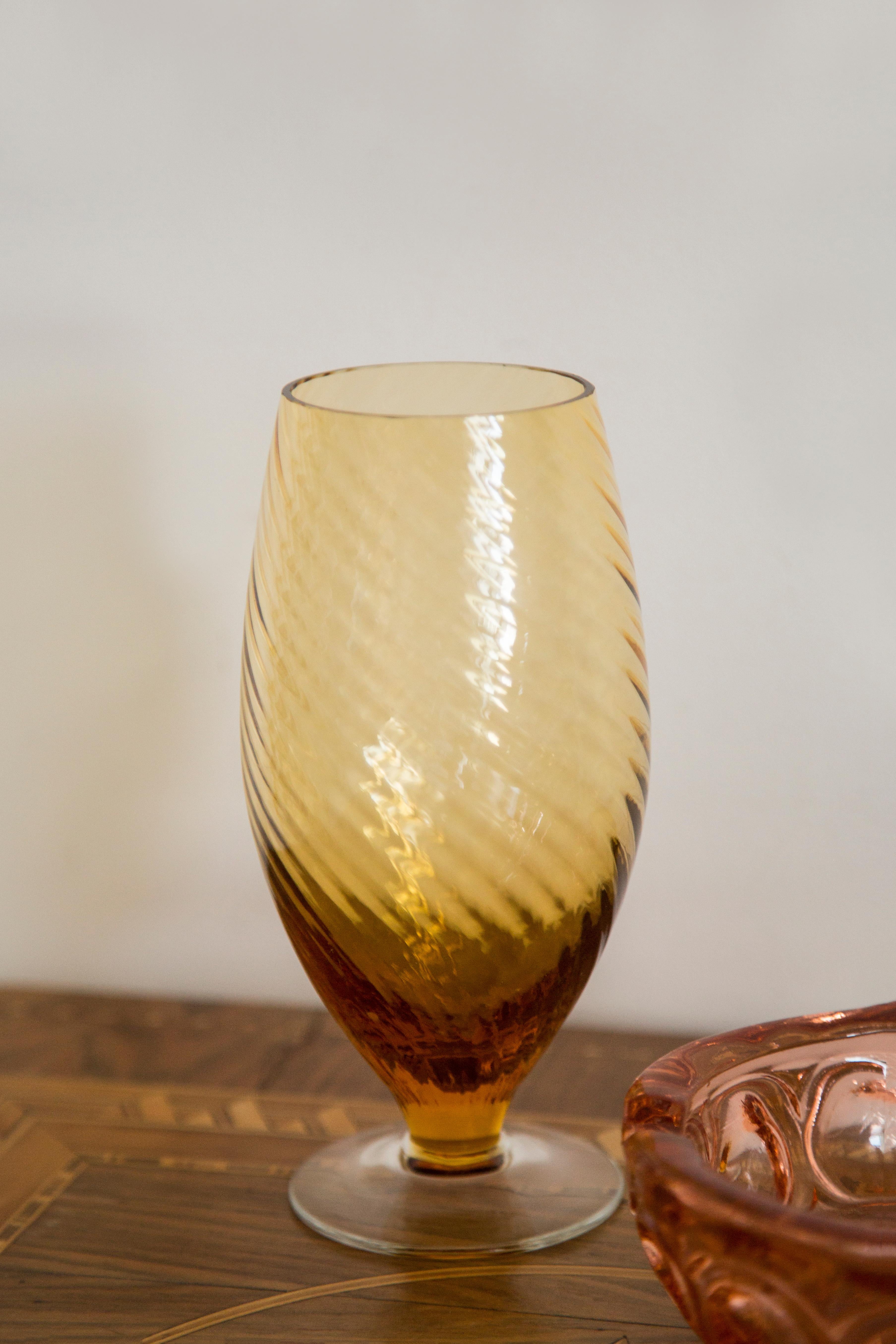 Produced in 1960s.

Pressed glass in original vintage condition.
The vase looks super good. 
The picture reflects the color in which it presents live.

The irregular surface of the object reflects and diffuses the light giving beautiful