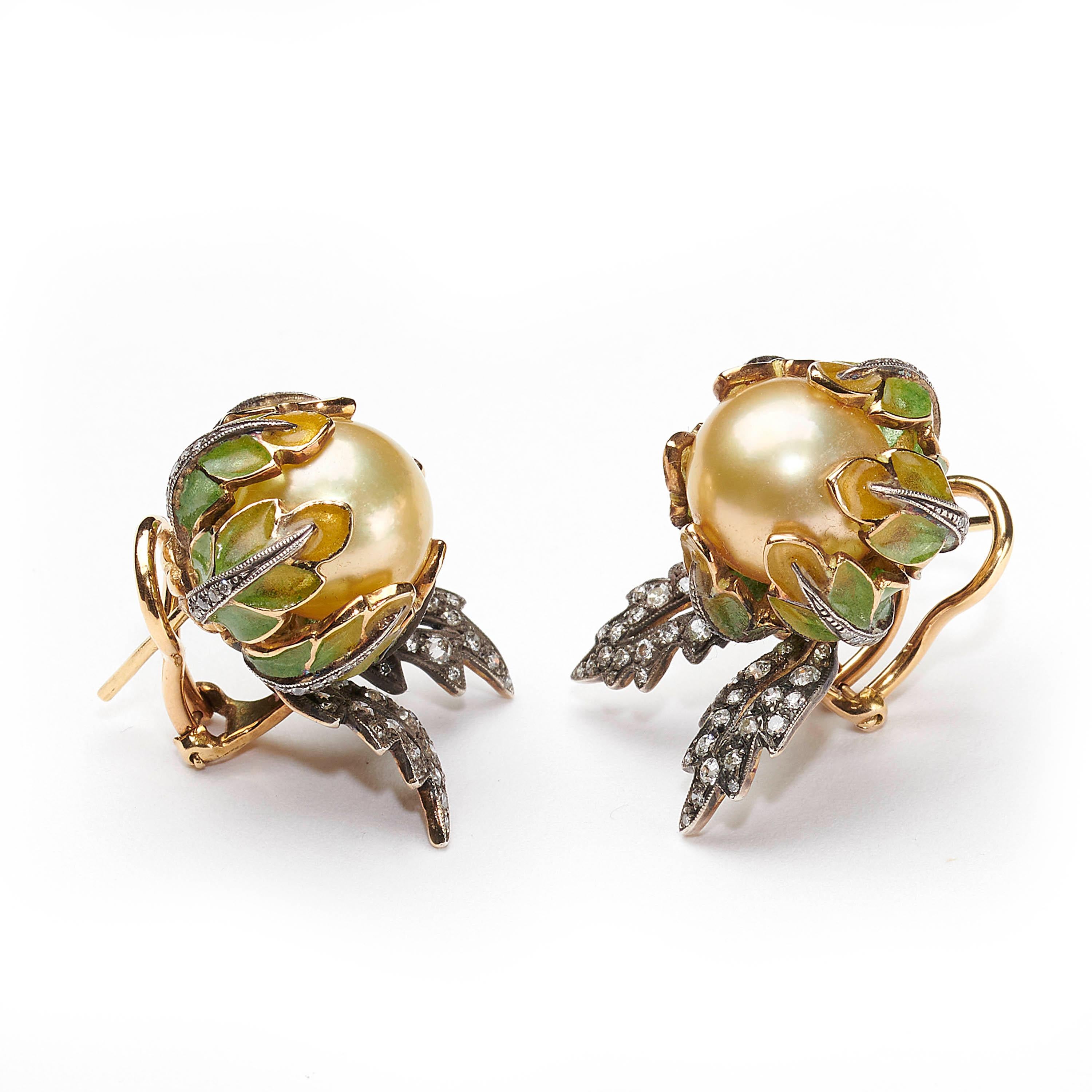 A pair of flower earrings, with yellow South Sea pearl centres, yellow to green plique à jour enamel petals and eight-cut and old-cut diamond set leaves, mounted in silver and 14 carat gold.