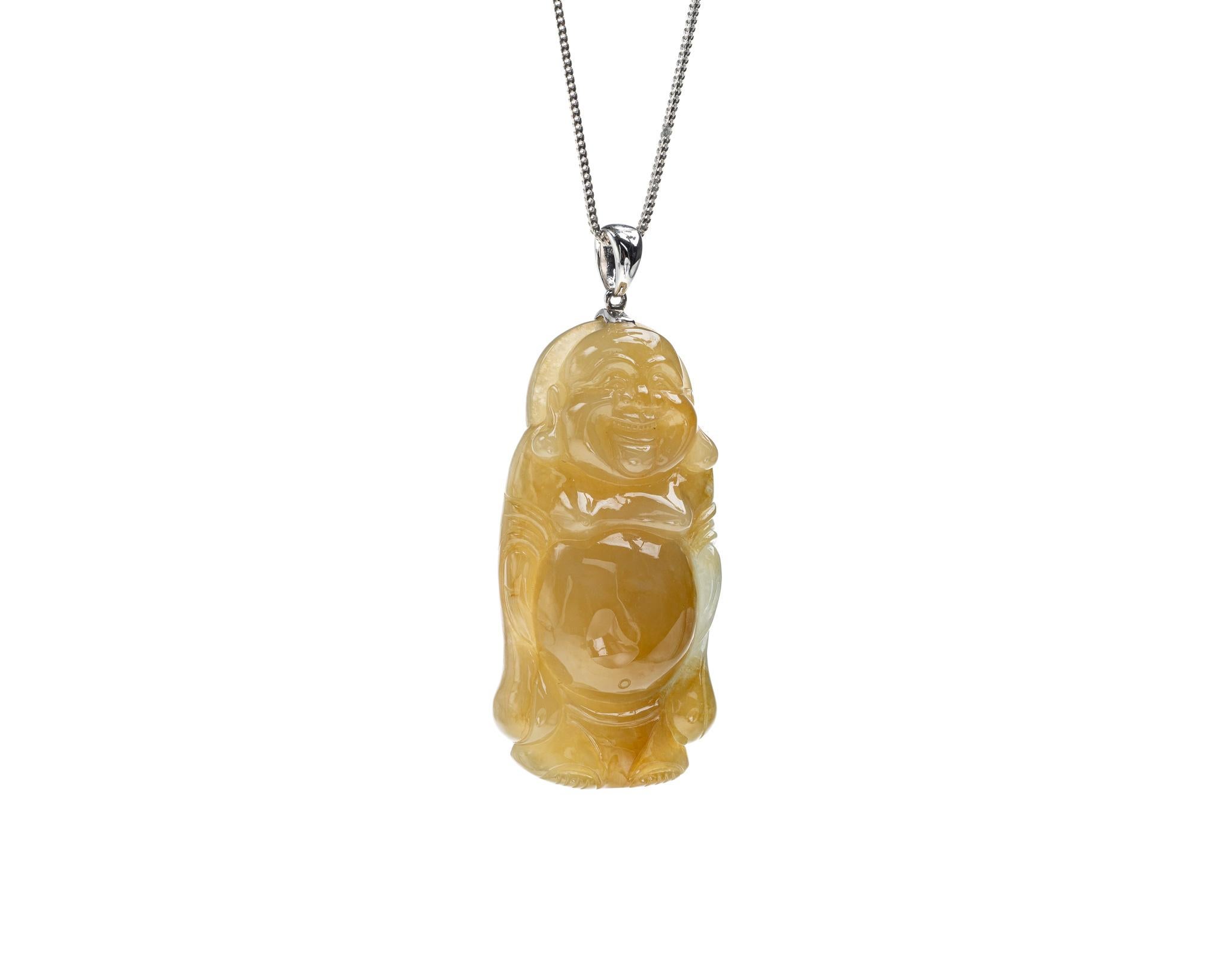 This is an all natural, untreated jadeite jade carved standing happy buddha and set on an 18K white gold bail.  The carved standing happy buddha symbolizes happiness, compassion and protection.    

It measures 2.06 inches (52.5 mm) x 0.96 inches