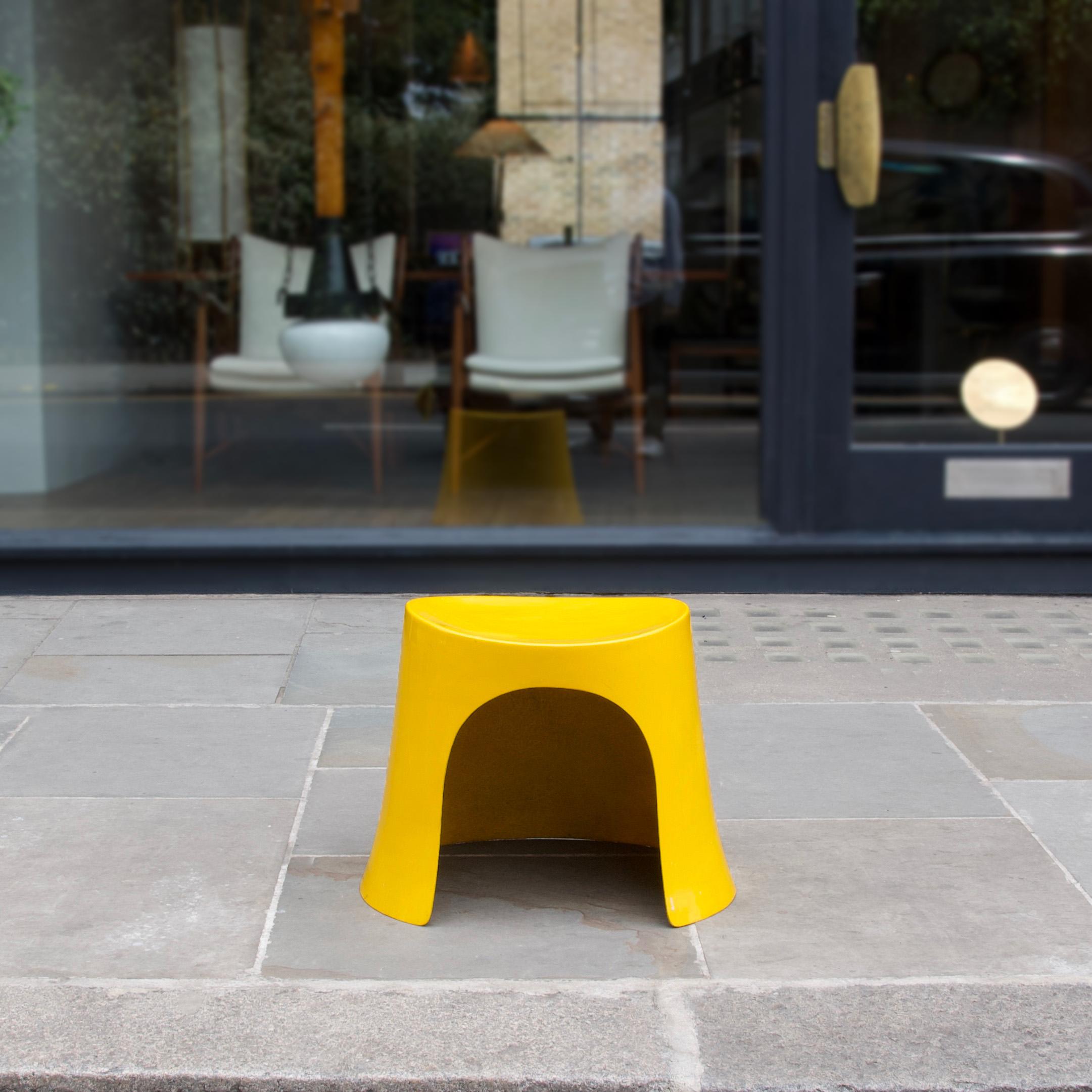 A vibrant yellow fibreglass stool designed by Nanna Ditzel for Domus Danica in 1969, after her move to London in 1968. In every aspect the stool is heavily influenced by the vitality of the 1960s -the space race, material/technical innovations, as