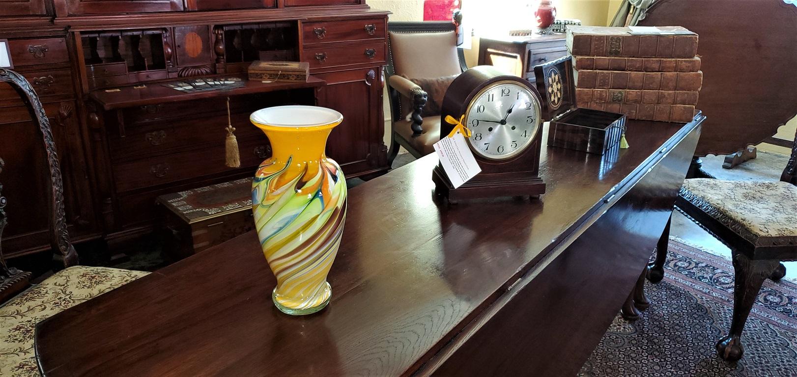 Lovely medium sized Murano glass vase from Murano, Venice, Italy.

20th century, circa 1960.

Midcentury in style.

Gorgeous hand blown piece with yellow color with hand blown swirls of blue, green, yellow and orange hues.

Unfortunately, it