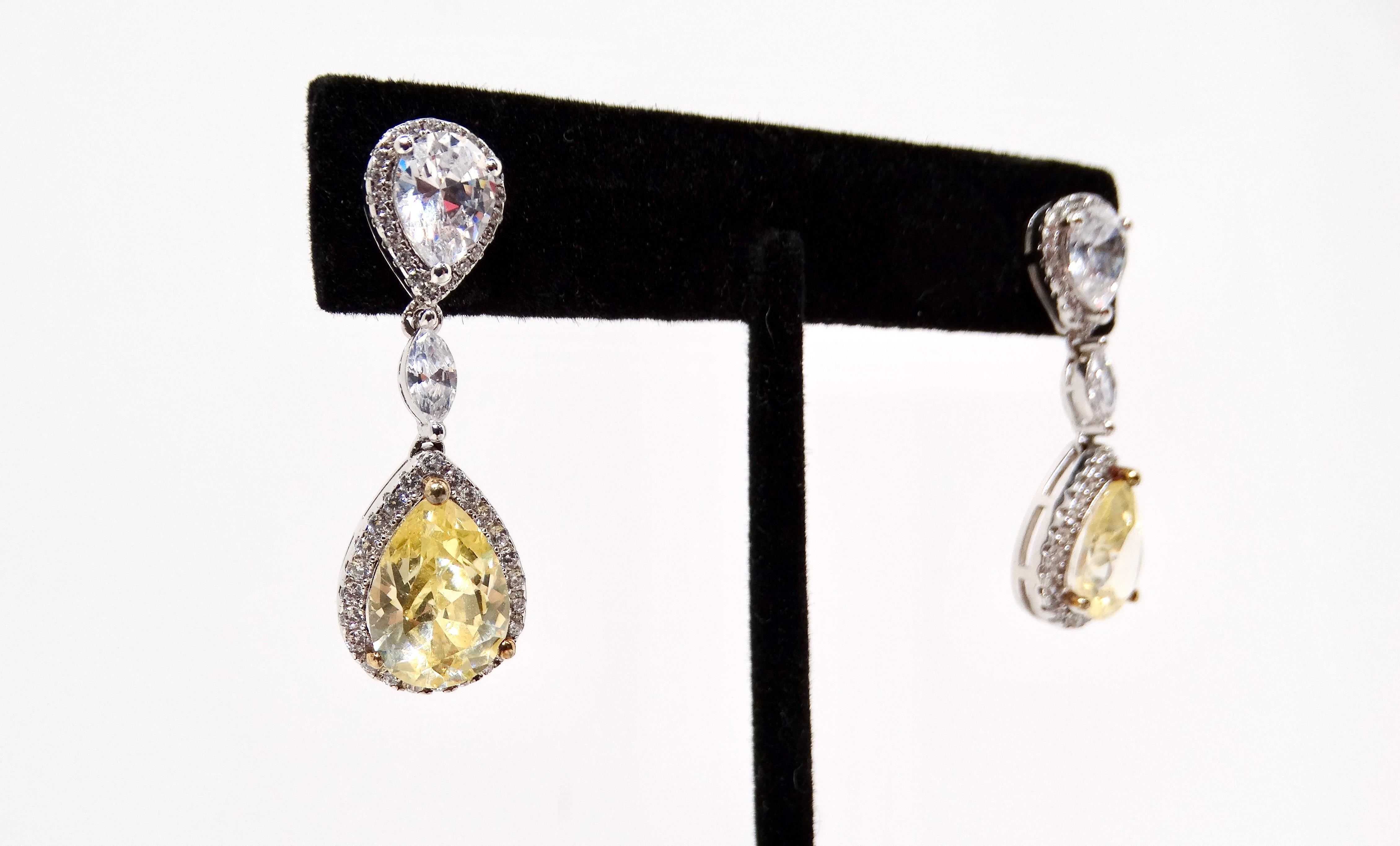 Elevate your jewelry collection with these exquisite Yellow Synthetic Diamonds & Sterling Silver Tear Drop Earrings. Designed in a classic tear drop shape, these earrings feature a smaller inverted teardrop at the top, adding a playful yet elegant