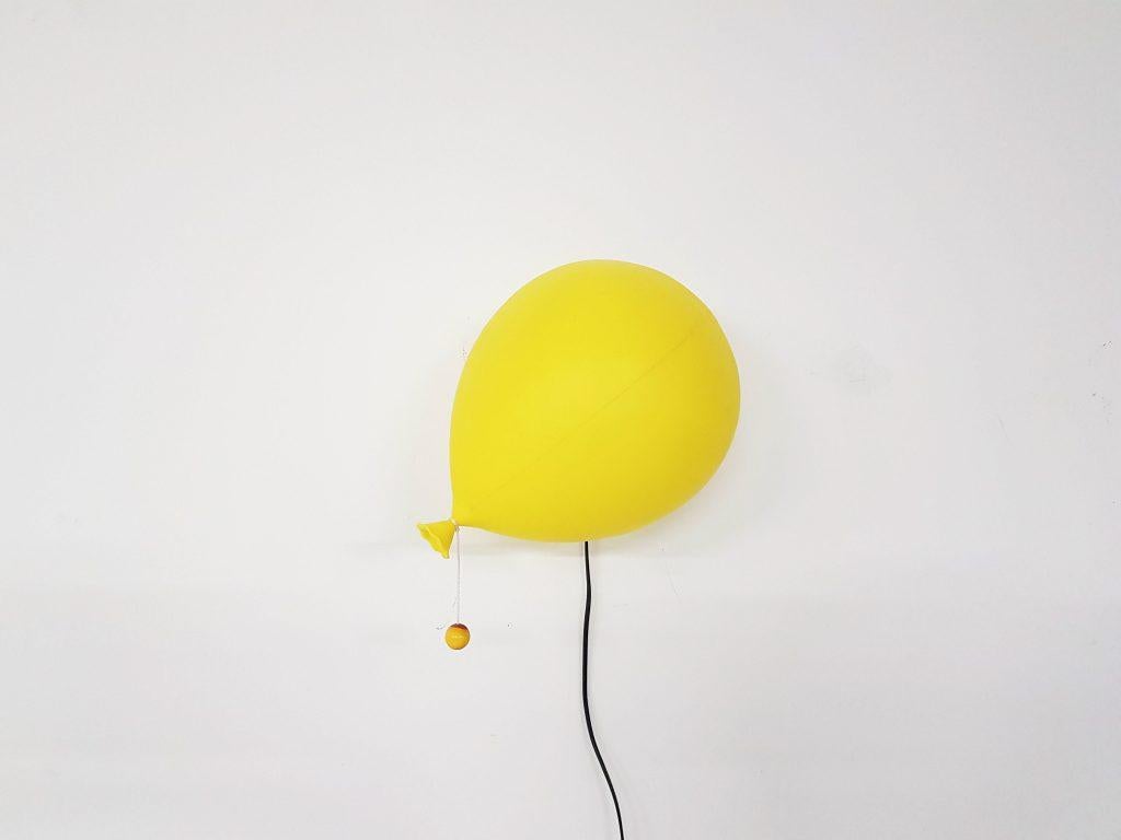 Iconic lamp which can be used as wall, ceiling or table light. When placed on the wall or ceiling it looks like a real floating gas balloon.

Lamp is made of yellow plastic on a black plastic base and has its original cord with marble. Original