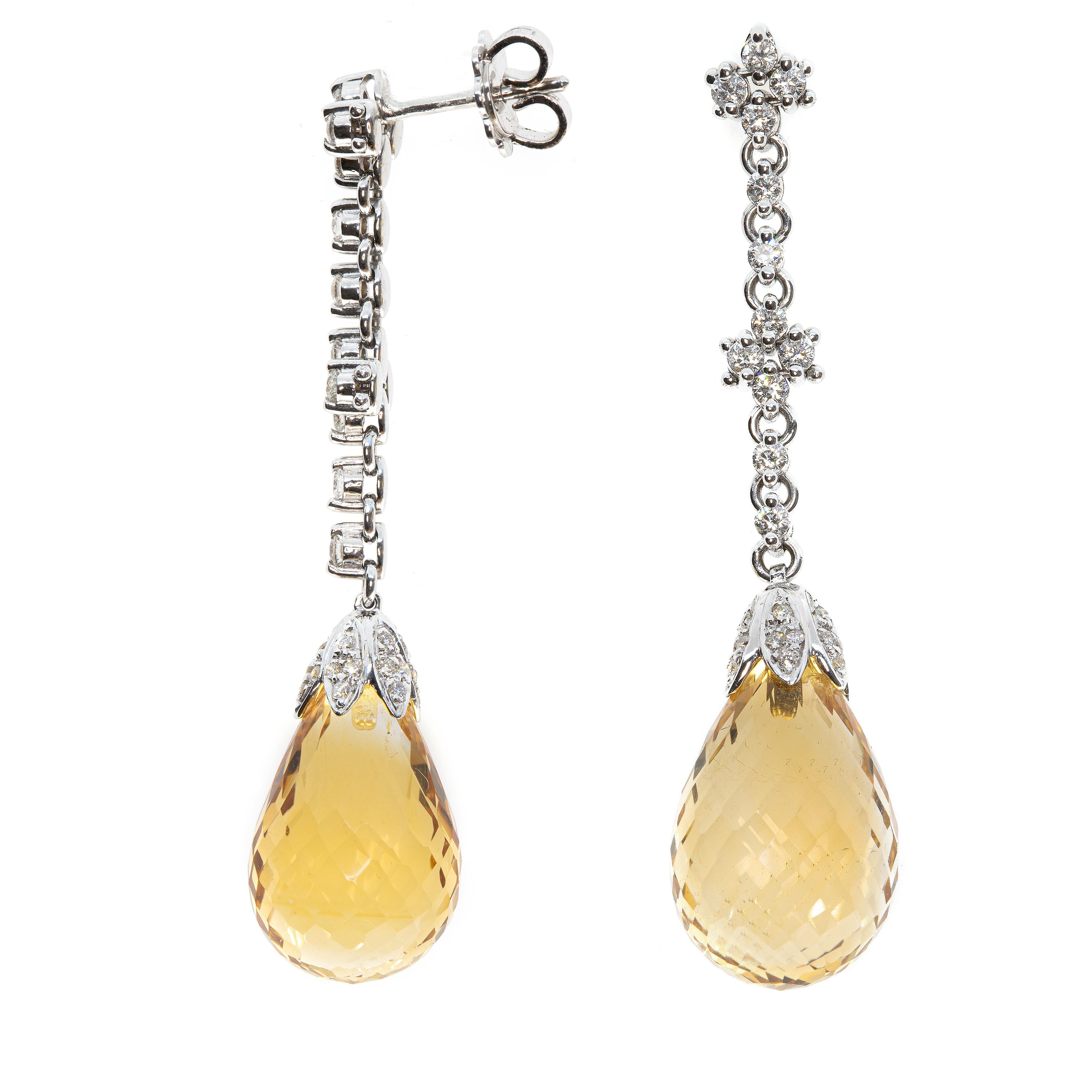 These delicate earrings, masterfully created by hand from 18-karat white gold each feature a stunning yellow topaz and white 30-carats diamonds, bezel and pavé-set. The topaz total 30-carats and is 1 centimetre accross. 

This is a delightful pair