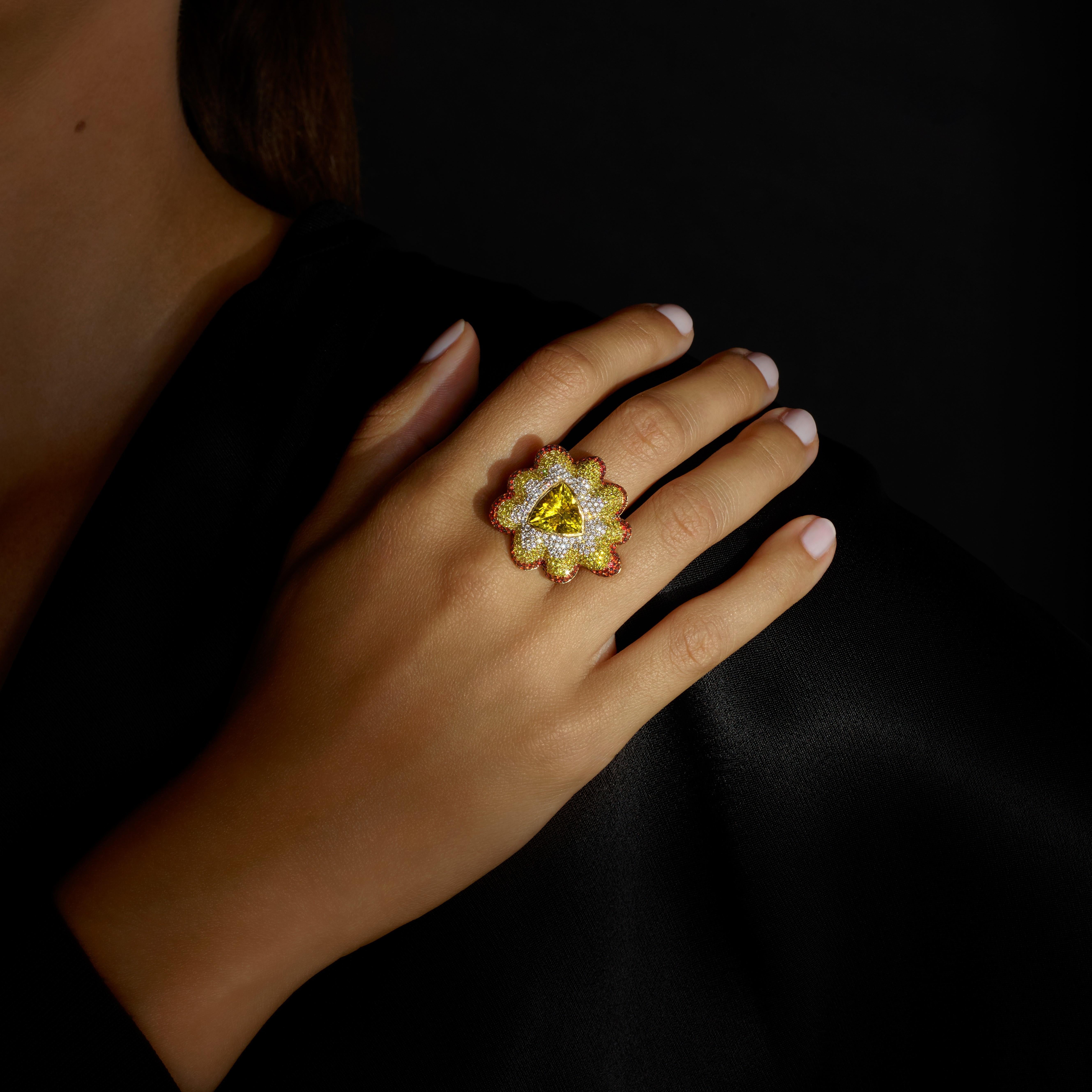 A One-off Cocktail Ring by Rosior in Portugal. 
It is set in yellow gold with:
- 1 Trillion cut Yellow Tourmaline weighing 4,05 ct;
- 215 Yellow Diamonds weighing 1,26 ct;
- 192 Orange Sapphires weighing 1,64 ct;
- 108 Colorless Natural Diamonds