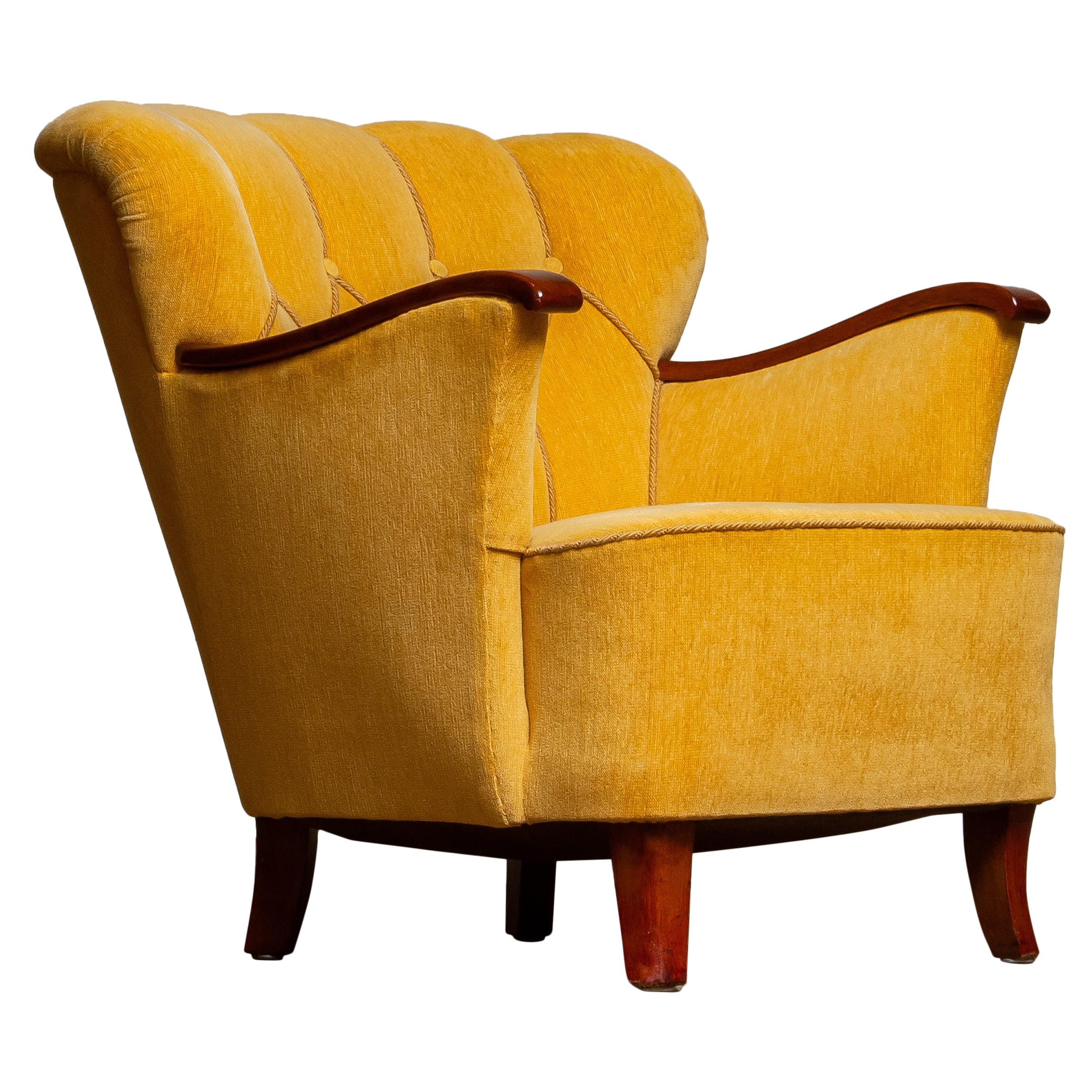 Very elegant and comfortable lounge / easy / club chair upholstered with yellow velvet and mahogany armrests.
The chair is overall in a good condition and supports perfect. Springs in the seat as well as the velvet upholstery are from a later
